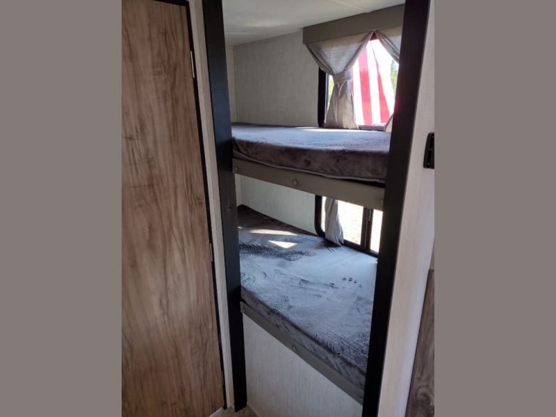 RV rental: Inside, cozy stacked bunk beds with mattresses. Ideal for family travel.. Forest River Palomino Palomini 2022