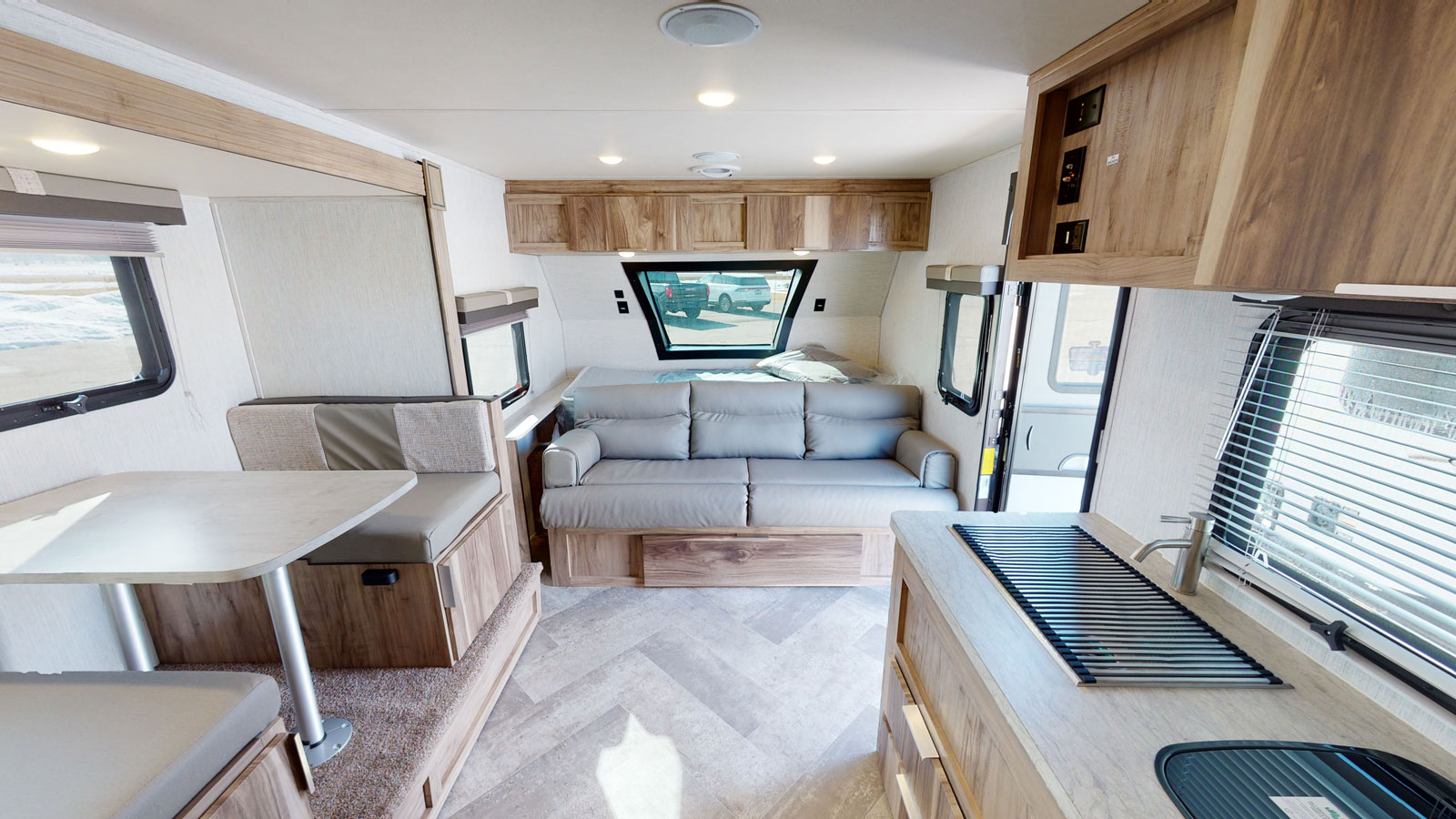 Bright RV rental interior: compact kitchen, cozy dinette, sofa bed. Perfect for your next adventure.. Forest River Palomino Palomini 2022