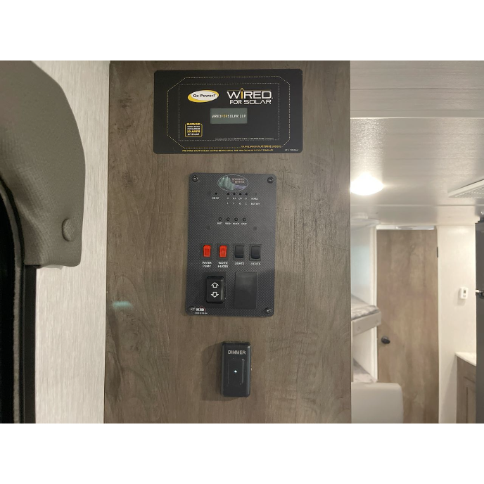 RV rental control panel: displays solar readiness, water & battery levels, controls water pump, lights, and dimmer.. Forest River Wildwood X-Lite 2022