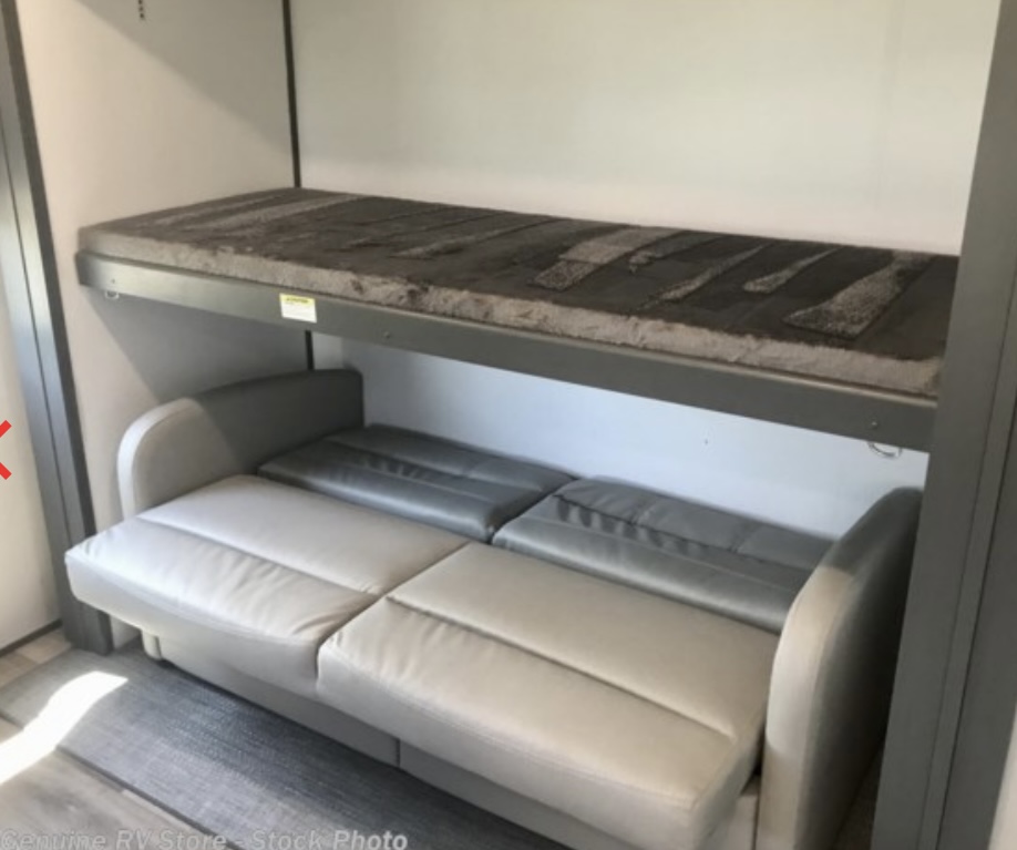This RV rental offers flexible sleeping: a lower light gray sofa pulls out, with a plush dark gray bunk bed above.. Keystone Premier 2022