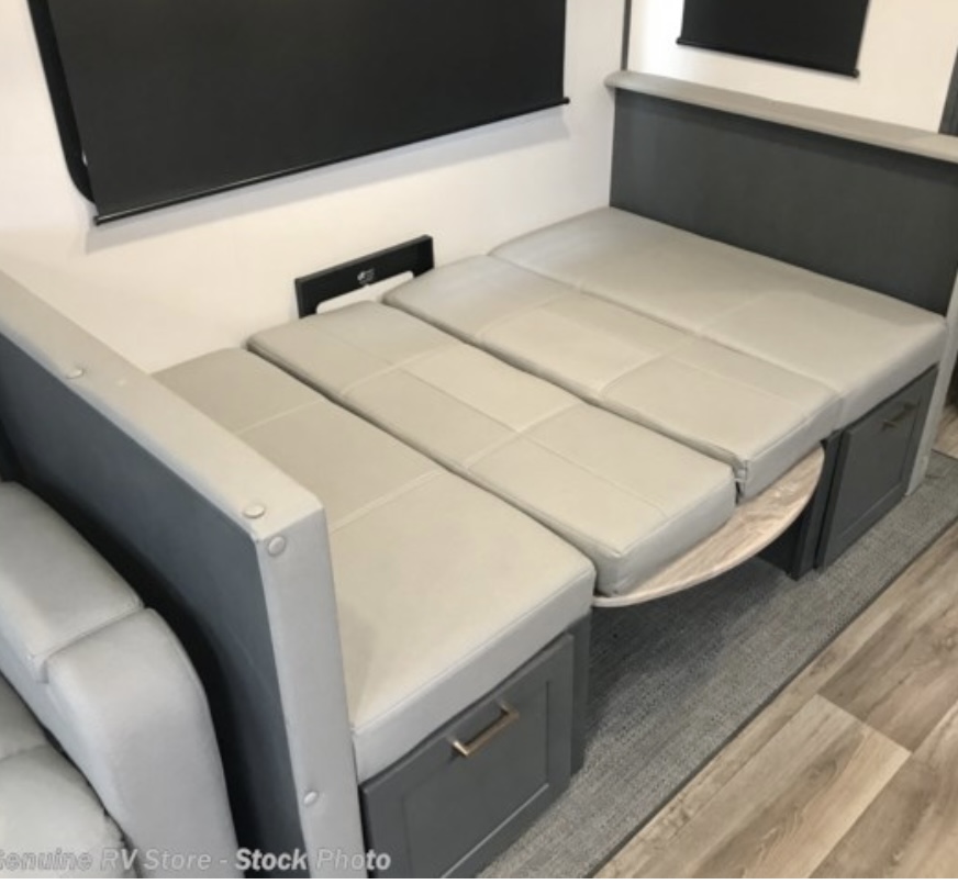 An RV rental's versatile light grey dinette converts into a bed with storage, showcasing smart interior design.. Keystone Premier 2022