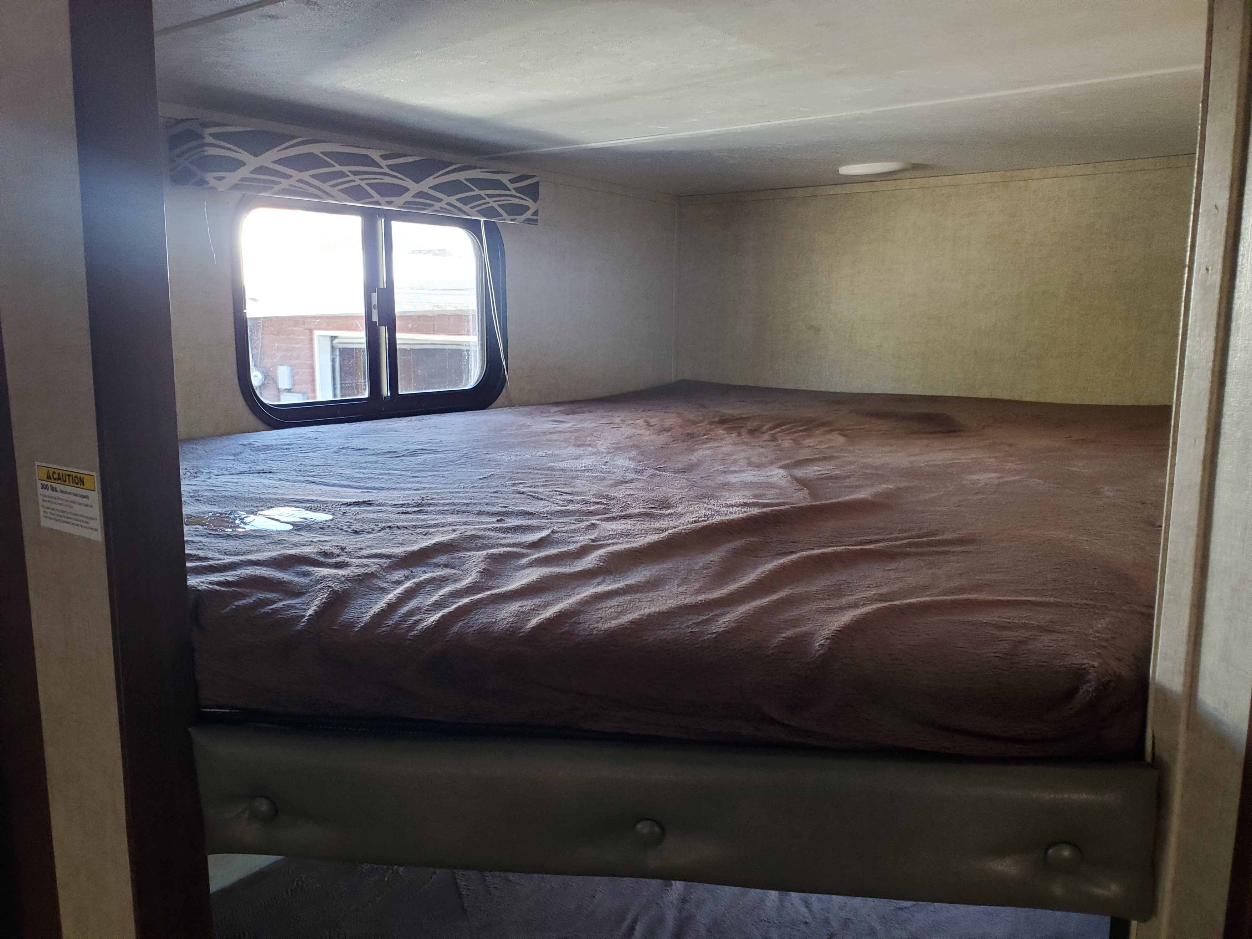 Top bunk is  queen sized. Keystone RV Hideout 2016