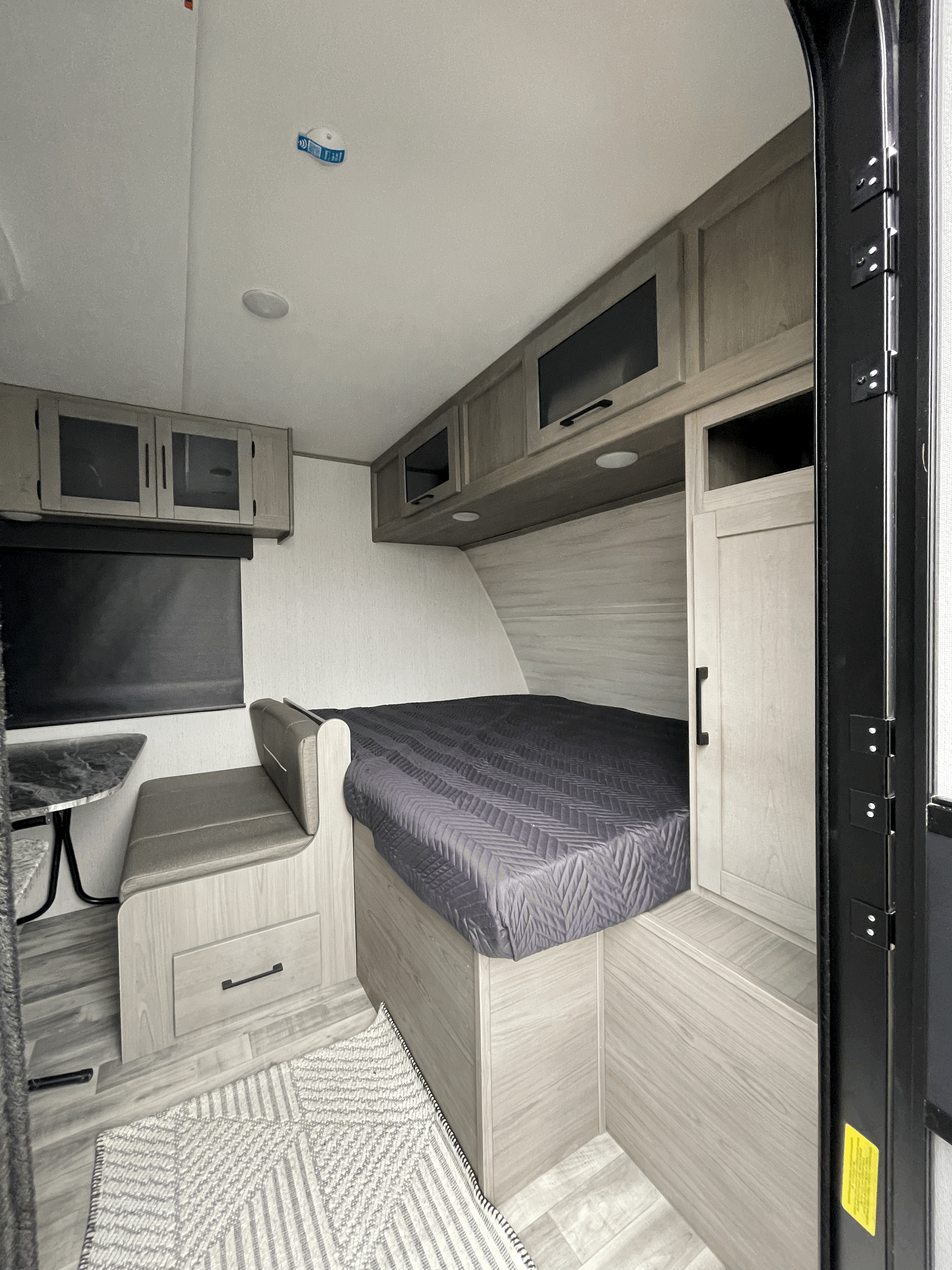 Inside this RV rental: a modern interior with a cozy bed, dinette, and ample storage cabinets.. Dutchmen Kodiak Cub 175BH 2022