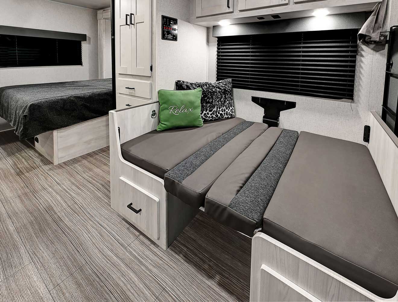 Spacious RV rental interior with a cozy bed, convertible dinette, and ample storage for comfortable adventures.. Forest River Entrada 2022