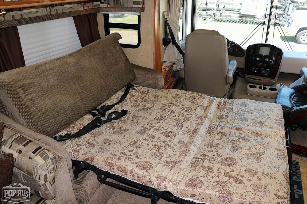 RV rental: Convertible sofa bed with floral mattress and RV cockpit in view. Comfortable living space.. Georgetown XL 2006