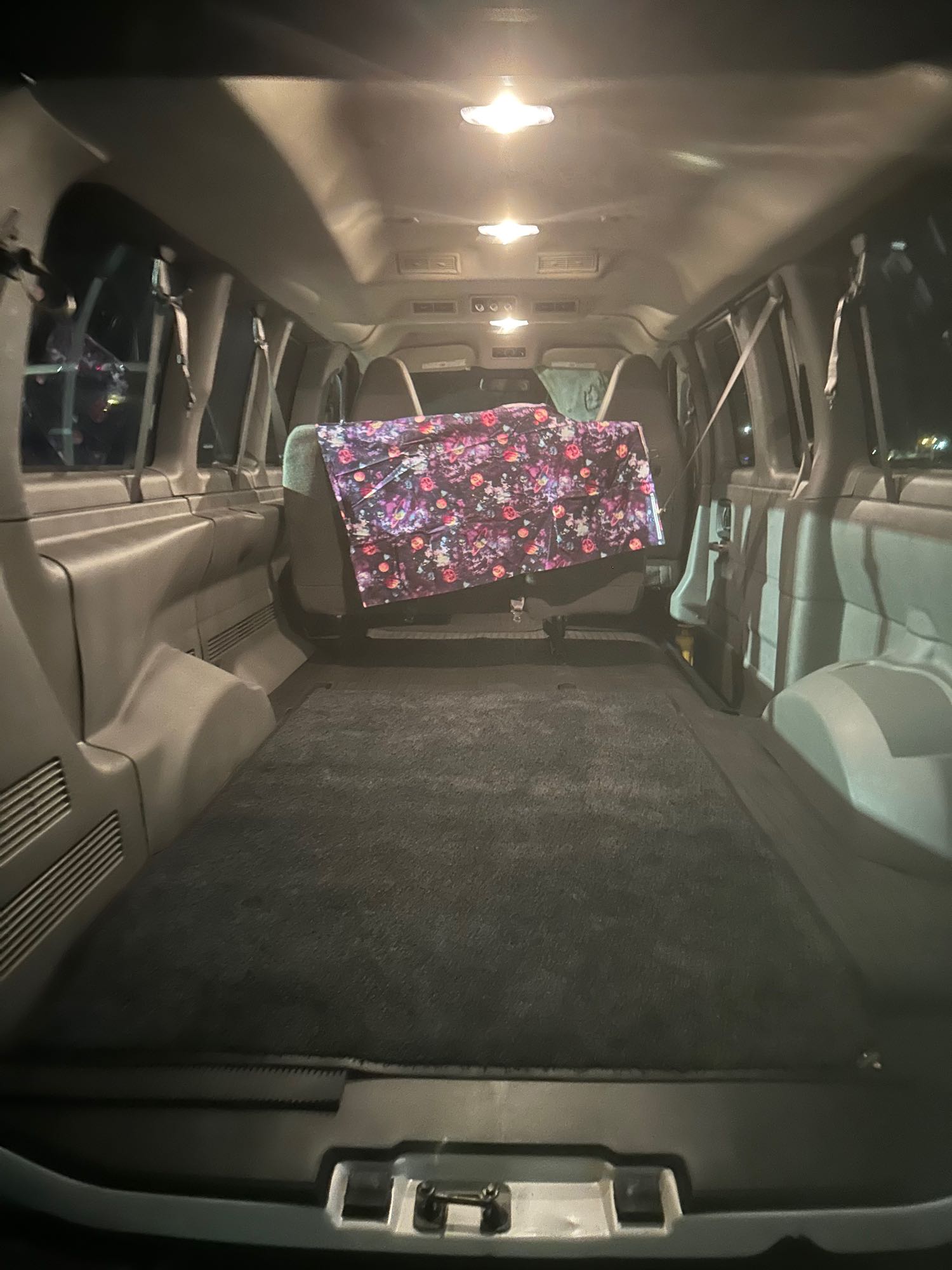 Spacious rv rental interior view from the back, showing a flat floor setup, comfort mat, and colorful blanket.. Chevrolet Other 2022