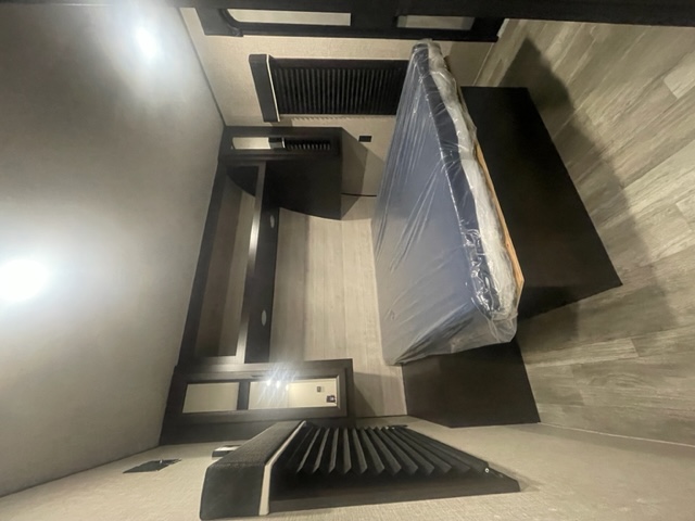 RV rental interior: A compact bedroom featuring a new, plastic-wrapped mattress and built-in storage, ready for adventure.. Jay Flight 286BHSW 286BHSW 2023