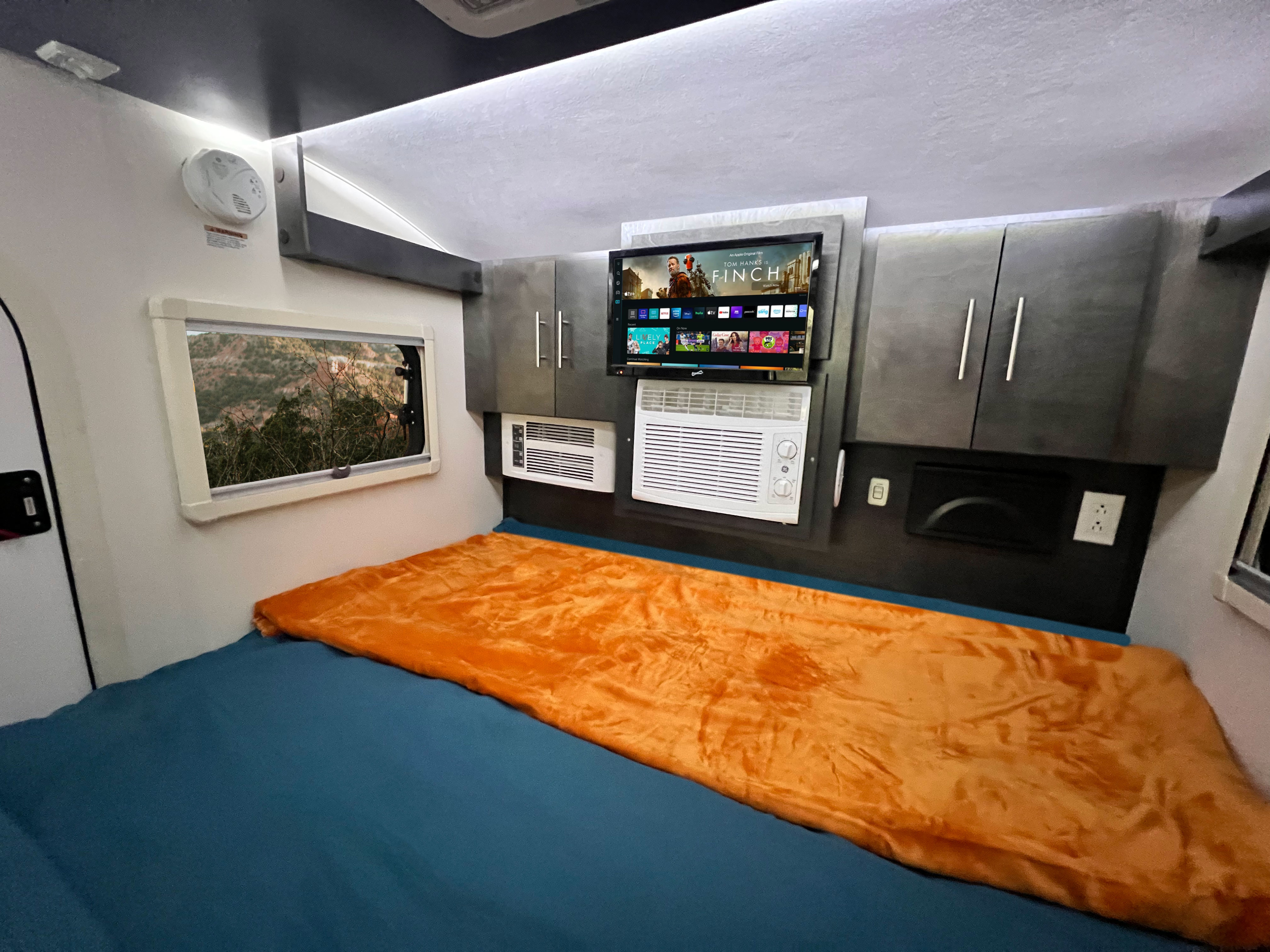 Welcome to the inside! King-size bed, storage, tv with Fire TV Stick & DVD player, heater & A/C, star-gazing window, blinds & screens & ceiling fan.. nuCamp RV T@G XL 2023