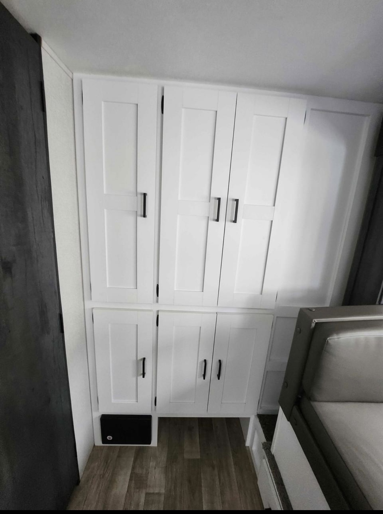 RV rental: Interior shows white cabinets, wood-look floor, and a light-colored sofa, with a black electrical panel.. Keystone Hideout 2021