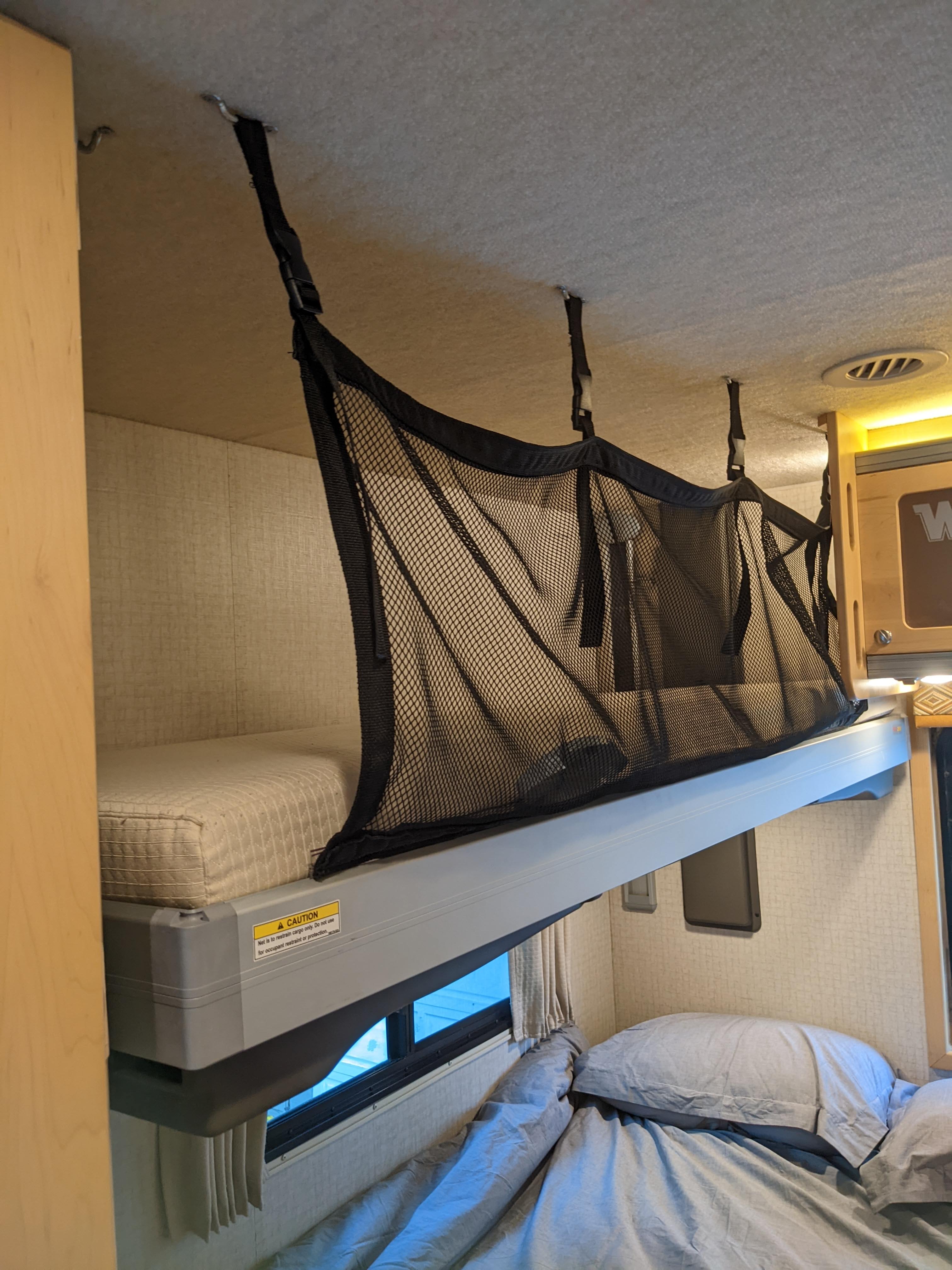RV rental: Elevated bunk bed with mesh cargo net & lower bed. Note: Net for cargo, not occupant safety.. Winnebago Brave 2015