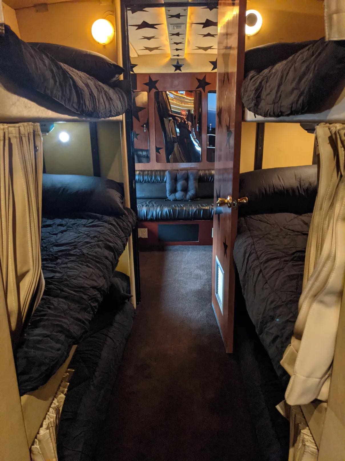 Cozy RV rental interior featuring bunk beds, a lounge area, and starry decor for comfortable road trips.. Other Other 2001