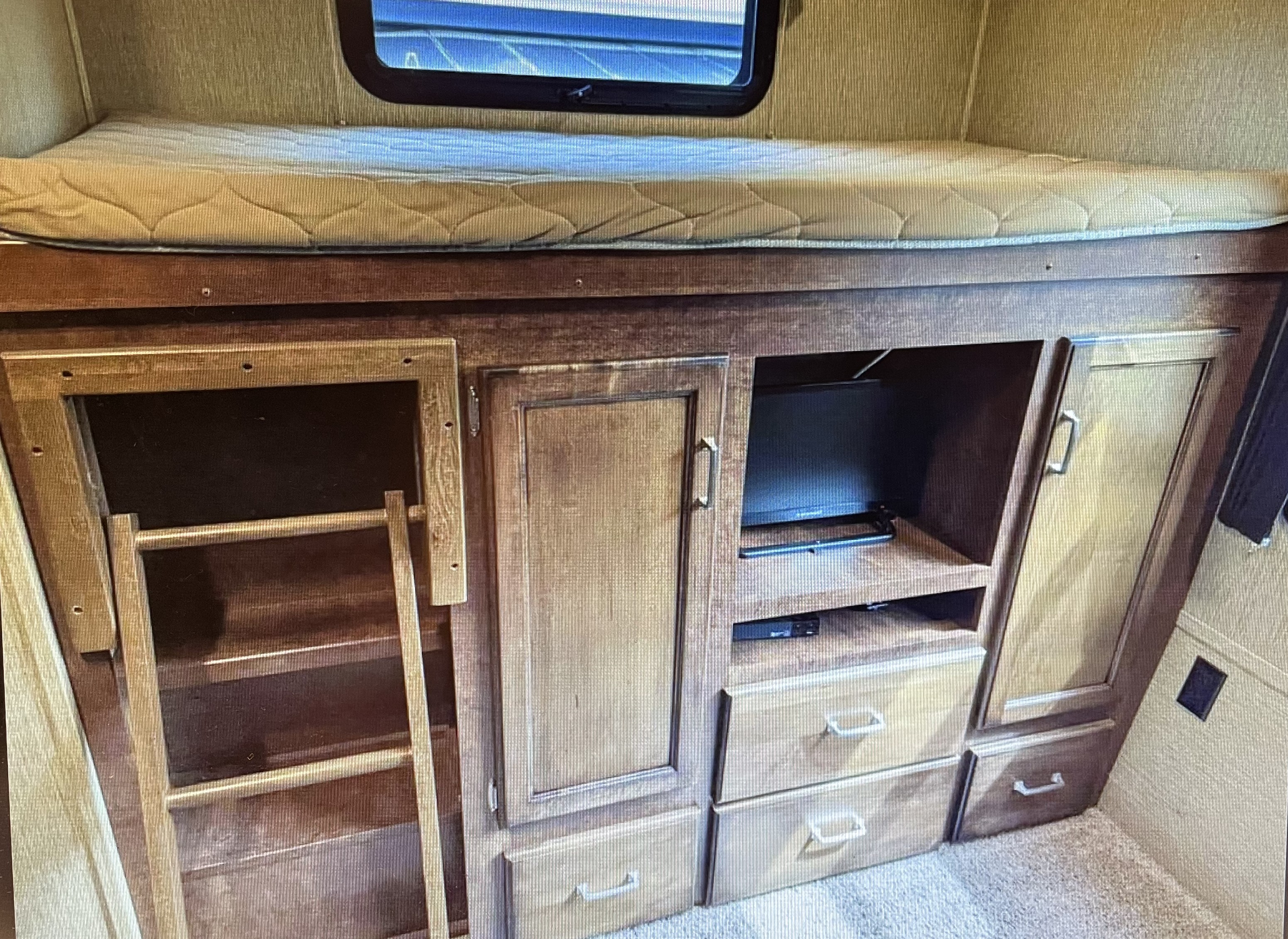 Cozy RV rental bunk bed area with integrated TV, ladder, cabinets & drawers for storage.. Keystone RV Outback Ultra-Lite 2017