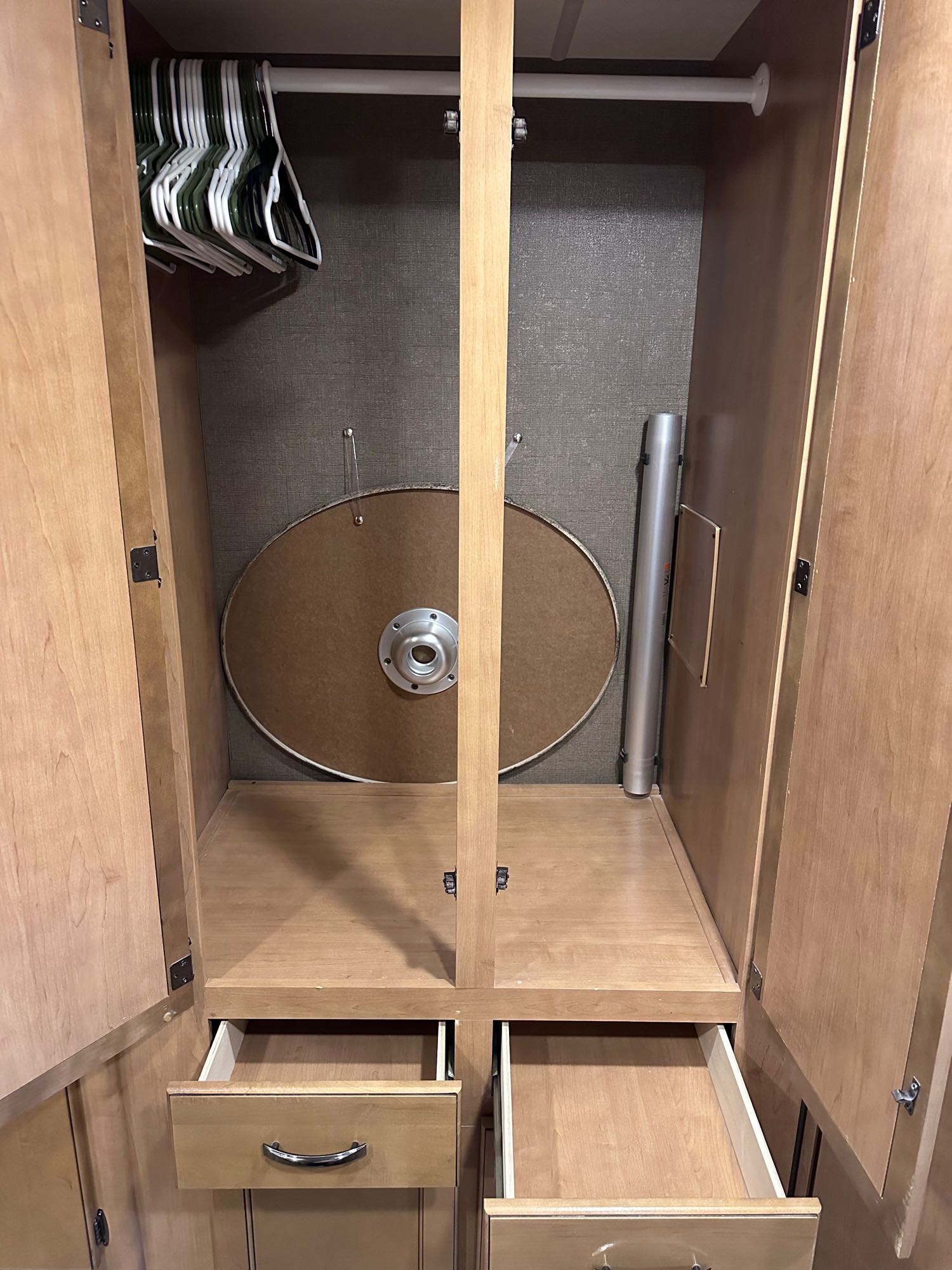 RV rental closet offers ample storage with hangers, a stowed round table top, and open drawers.. Thor A.C.E. 2017