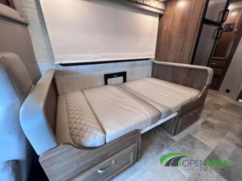RV rental interior: Versatile dinette sofa converts to a comfortable bed, with light cushions & wood cabinetry.. Gulf Stream B Touring 2020