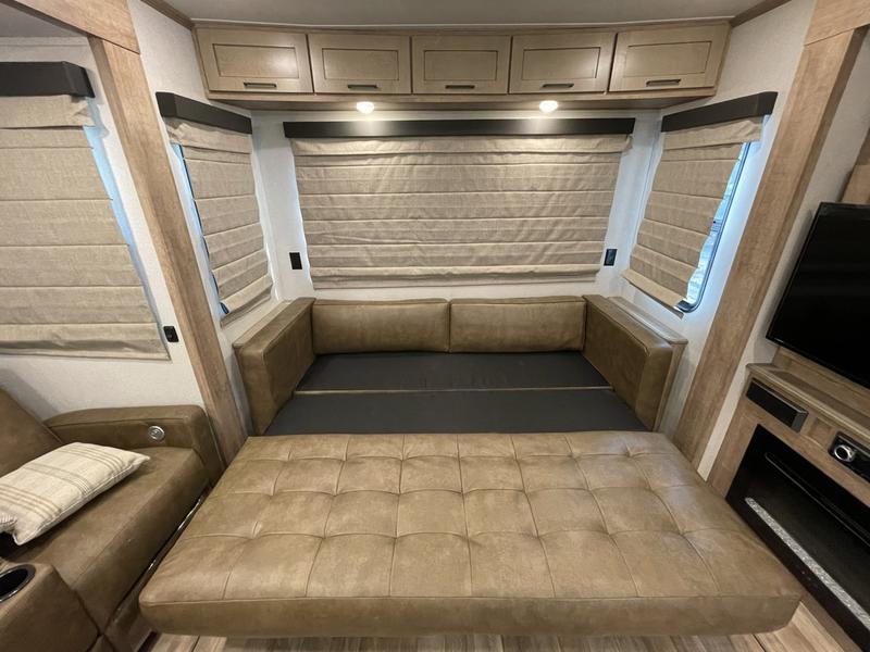 Spacious RV rental interior with a large, comfortable convertible sofa bed, perfect for relaxing travel.. Keystone RV Arcadia 2022