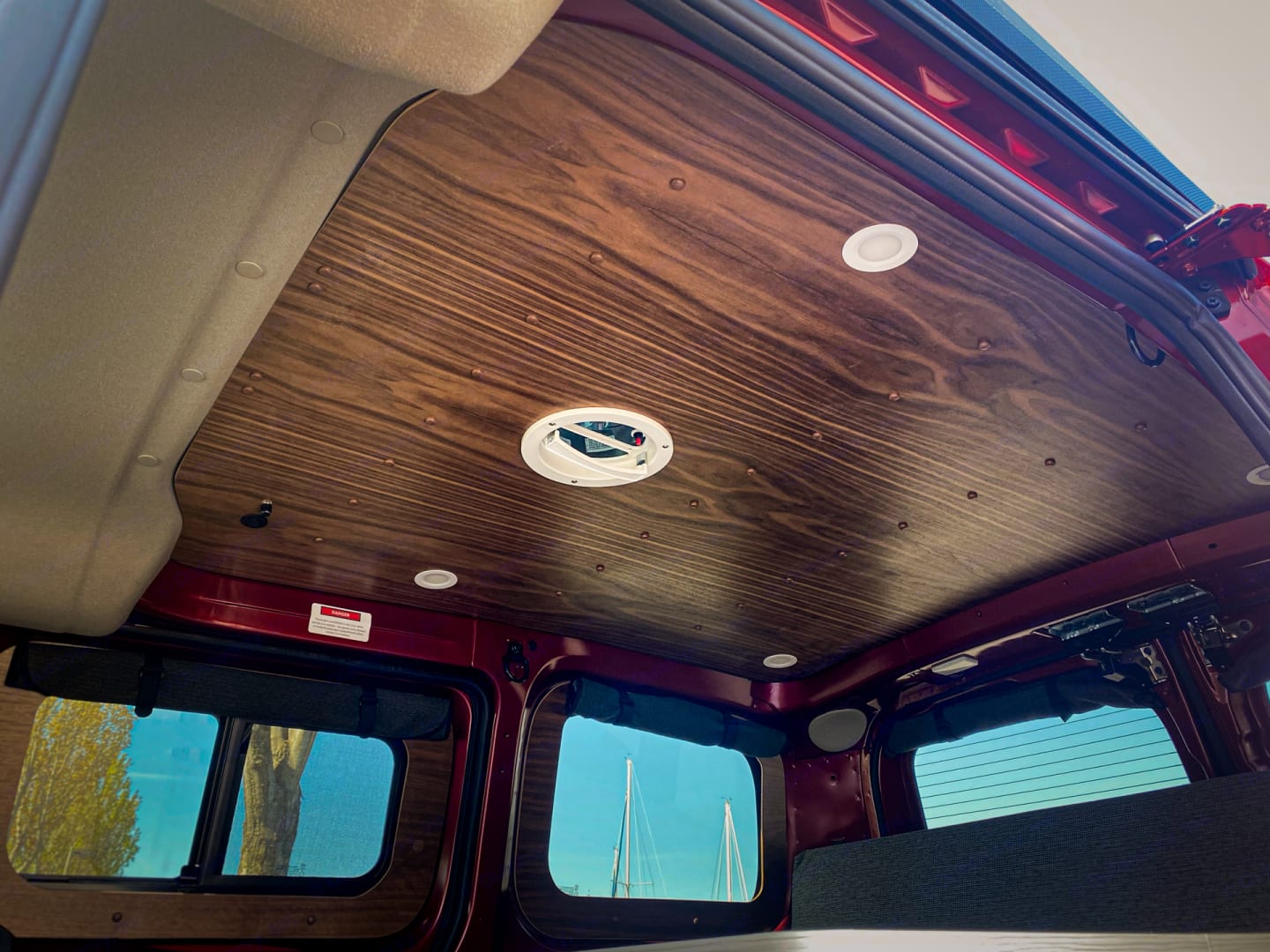 Experience comfort in this rv rental! Features a stylish wood-paneled ceiling with recessed LED lights and a central fan.. Nissan NV200 SV 2021
