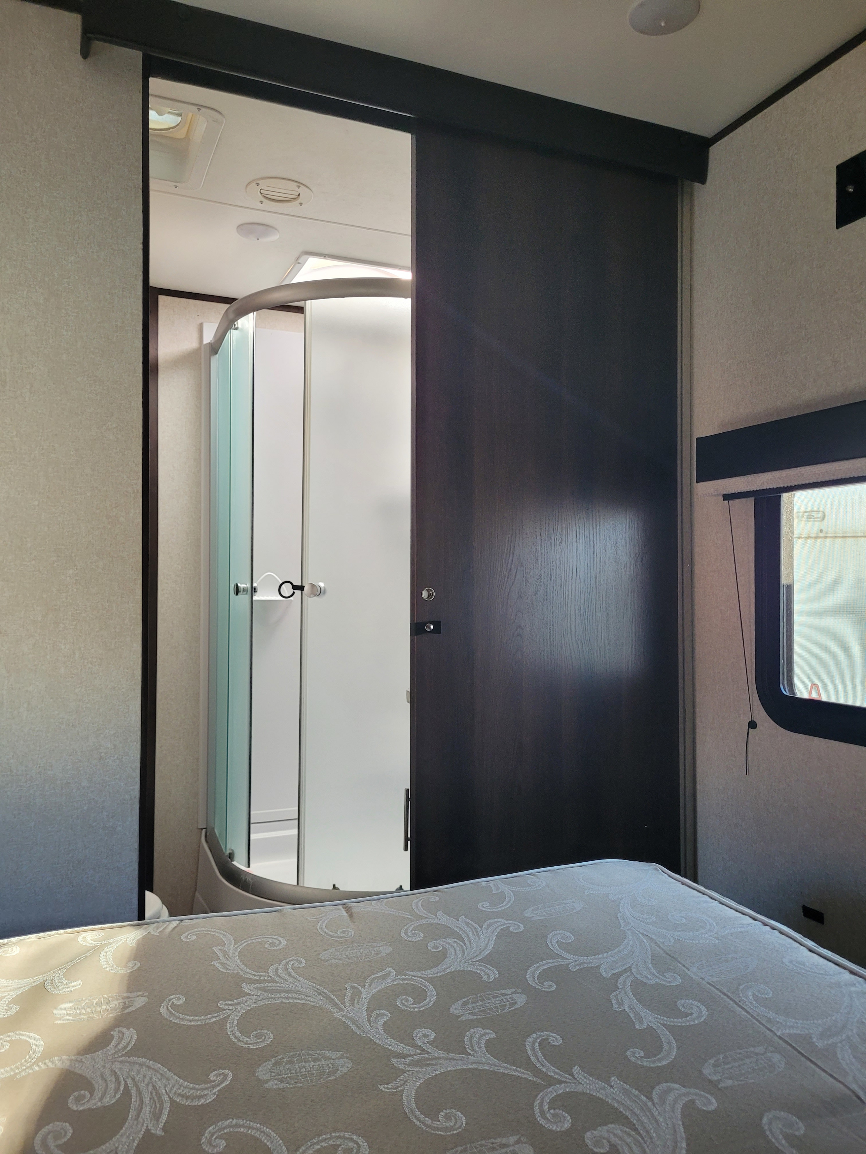 Tour an RV rental's clever design, featuring a comfortable bedroom and a space-saving shower behind a sliding door.. Jayco Jay Flight SLX 2018