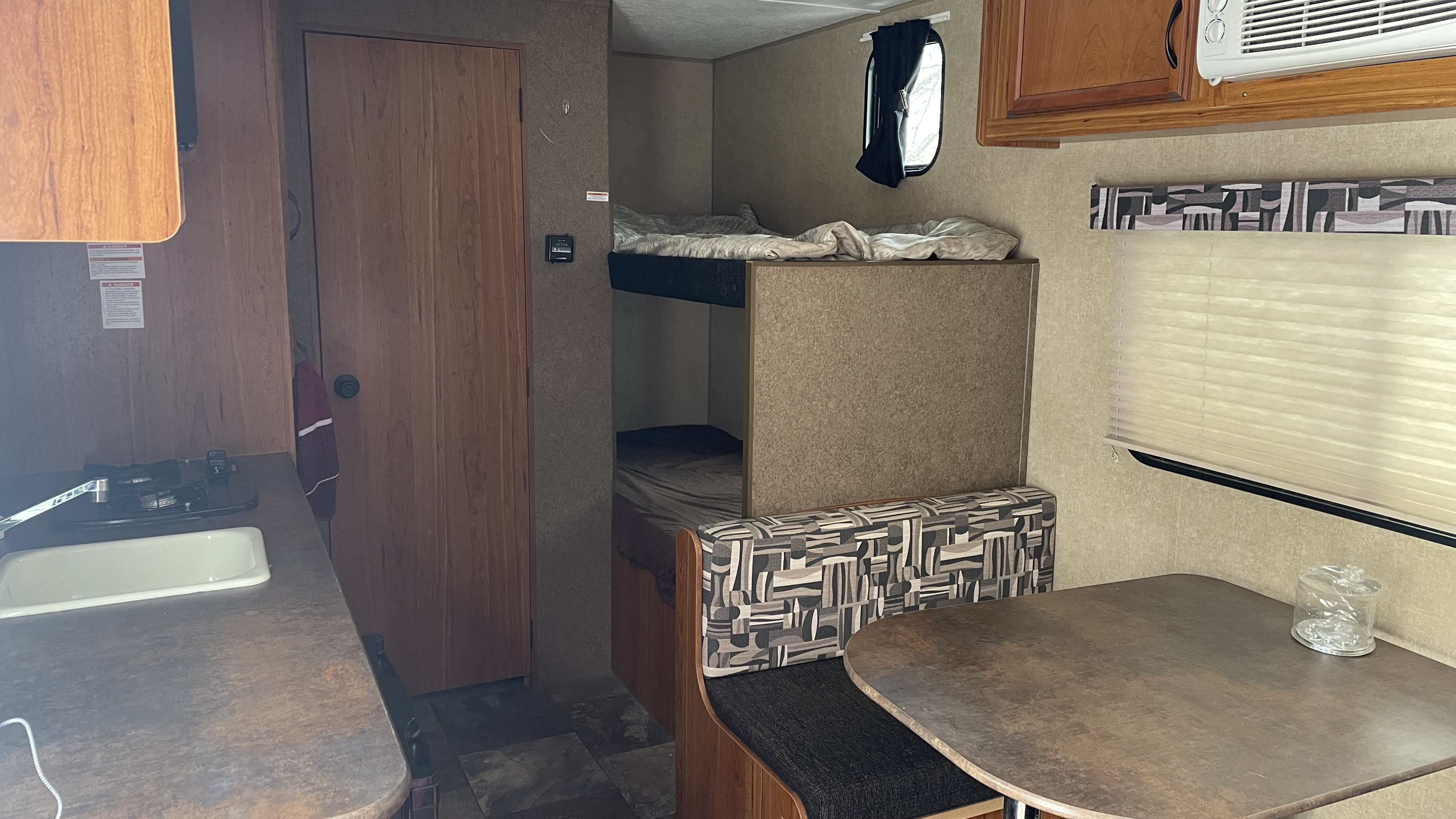 Inside an RV rental: kitchen, bunk beds, and dinette area visible, offering a cozy space for travel.. Starcraft AR-One Maxx 2016