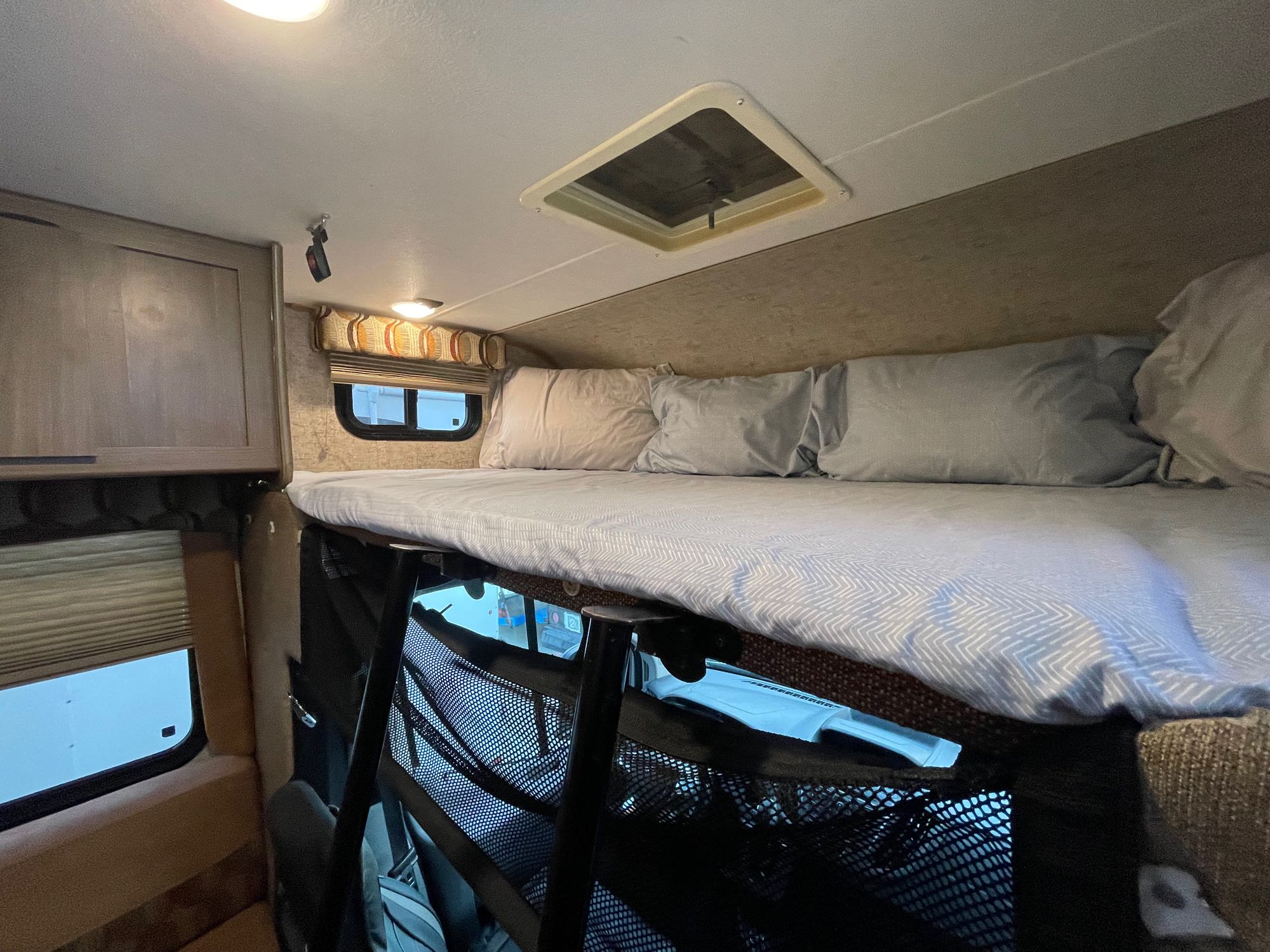 Experience comfort in this RV rental! Features a cozy cab-over bed with skylight, cabinets, and mesh storage.. Forest River Coachmen Freelander Micro 2018