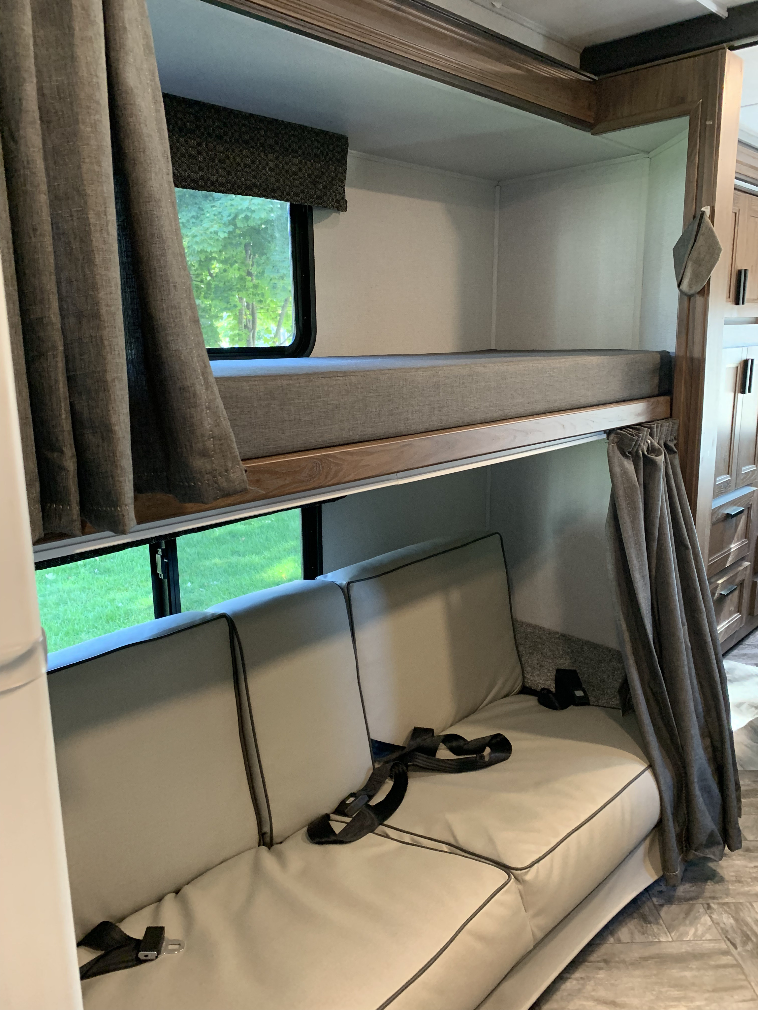 RV rental interior featuring a cozy bunk bed setup above a. Forest River Sunseeker LE 2022