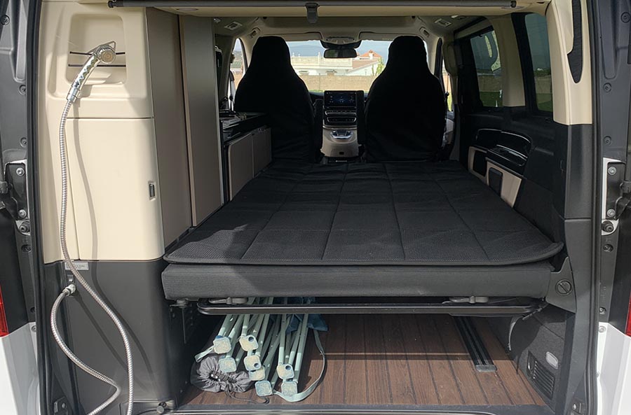 RV rental camper van interior. Features a foldable bed, under-bed storage, and a rear shower.. Mercedes Marco Polo Westfalia 2022