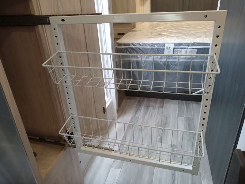 RV rental: White metal pull-out shelving with two wire baskets, ideal for RV storage in a closet.. Forest River Forester 2024