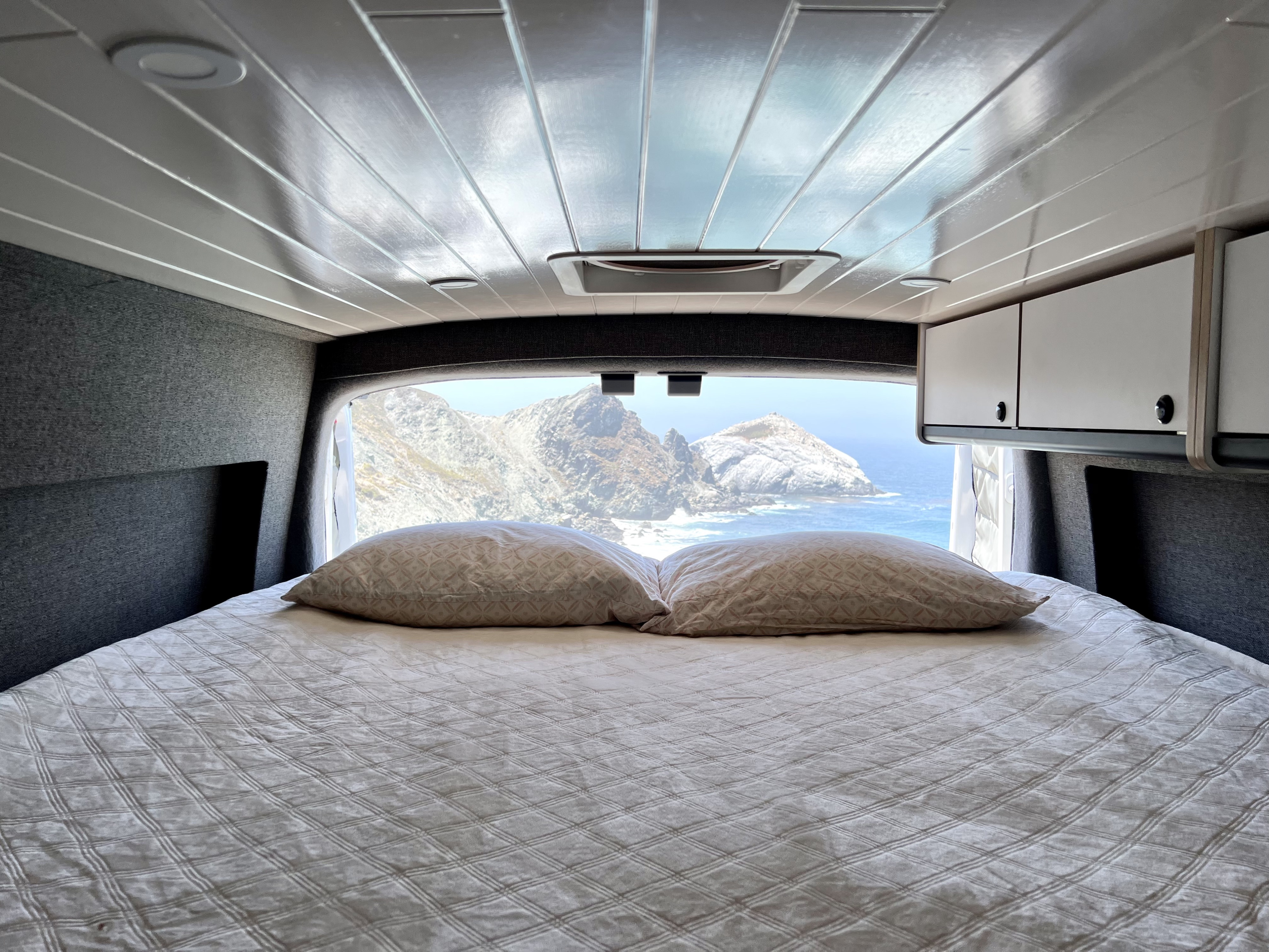RV rental comfort: Enjoy breathtaking ocean views and rocky coastal mountains from your cozy bed in this camper van.. Ford Transit 2020