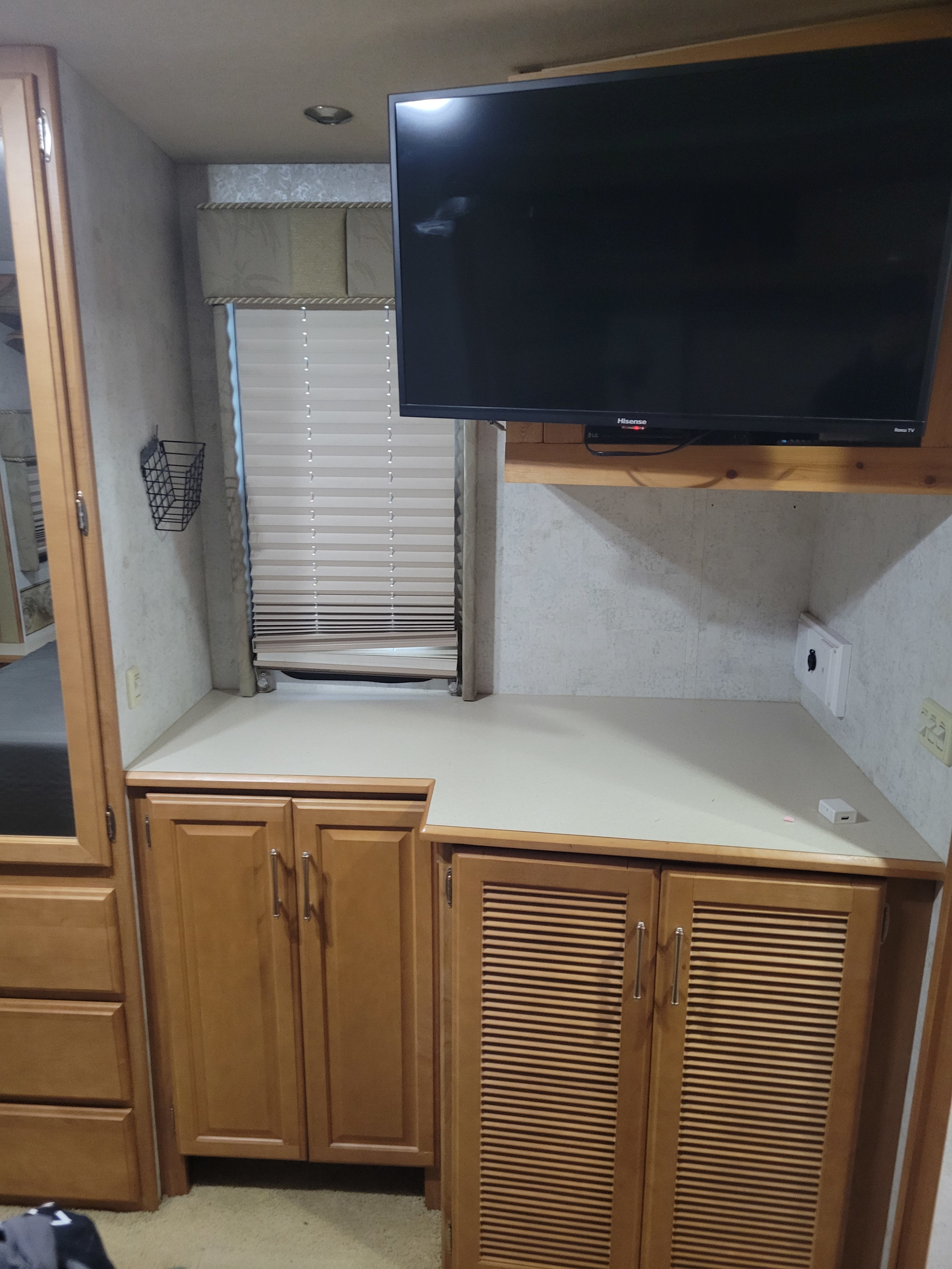 RV rental: Functional bedroom/living space with TV for entertainment, ample cabinets, and window blinds.. Winnebago Adventurer 2005
