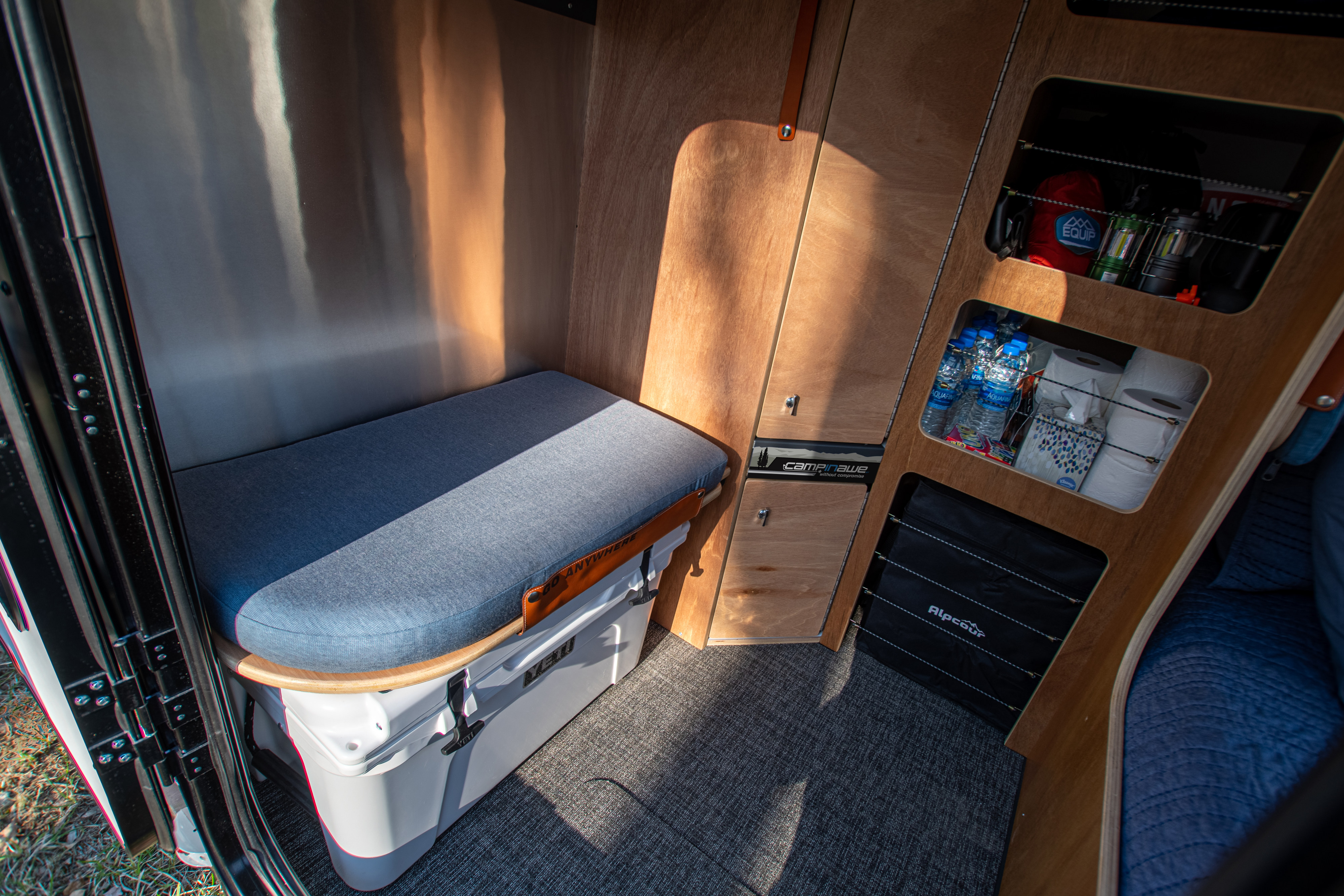 Explore this RV rental: comfy bench over Yeti cooler & organized wooden storage for all your gear.. campinawe sport trailer 2023