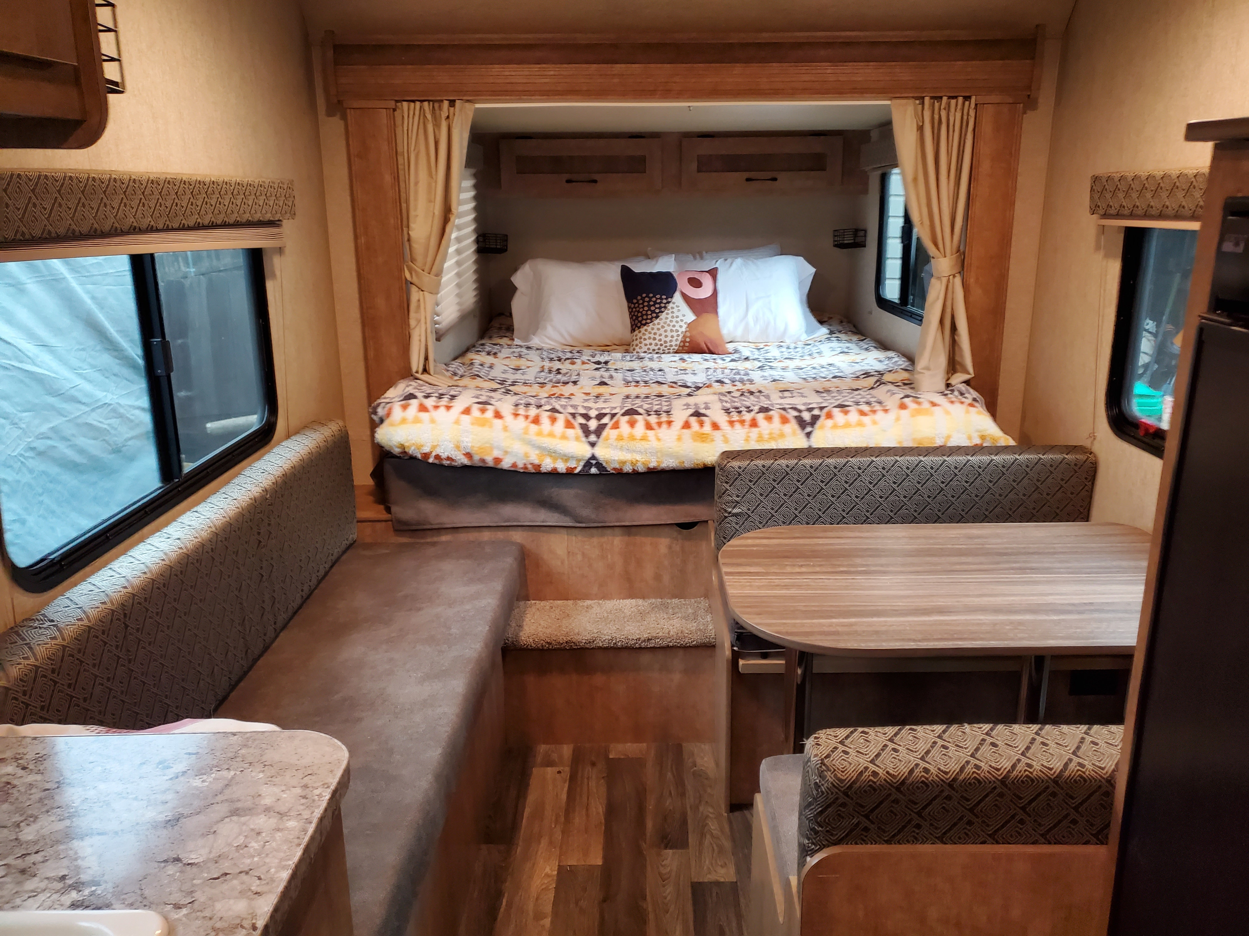 Cozy RV rental interior showing a comfortable bed, dinette, and living area for your travel adventures.. Starcraft Launch Mini Extreme 2017