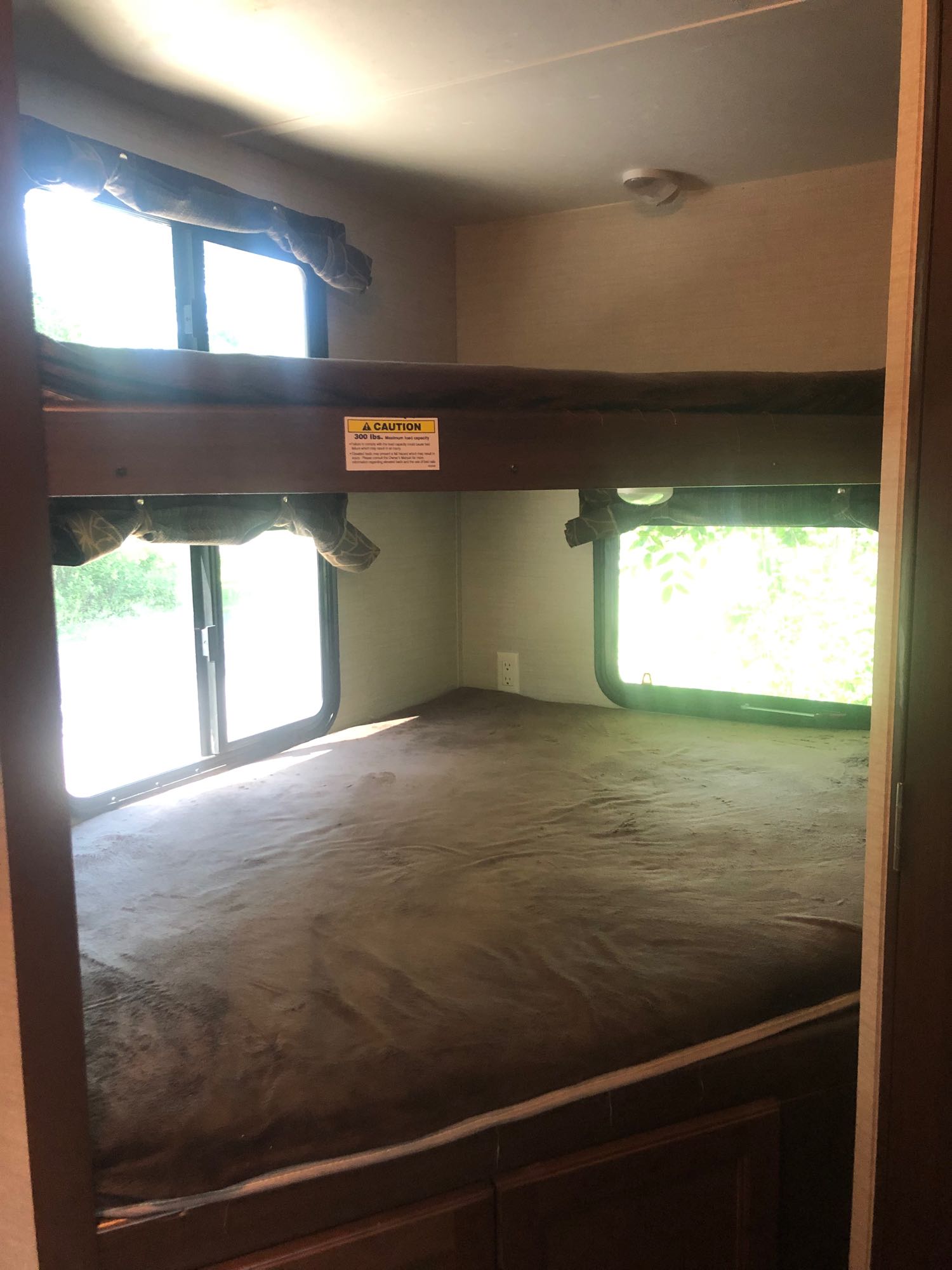 RV rental bunk beds: cozy sleeping space with bright windows. Top bunk capacity 300 lbs, perfect for travel.. Keystone RV Bullet Ultra Lite 2017
