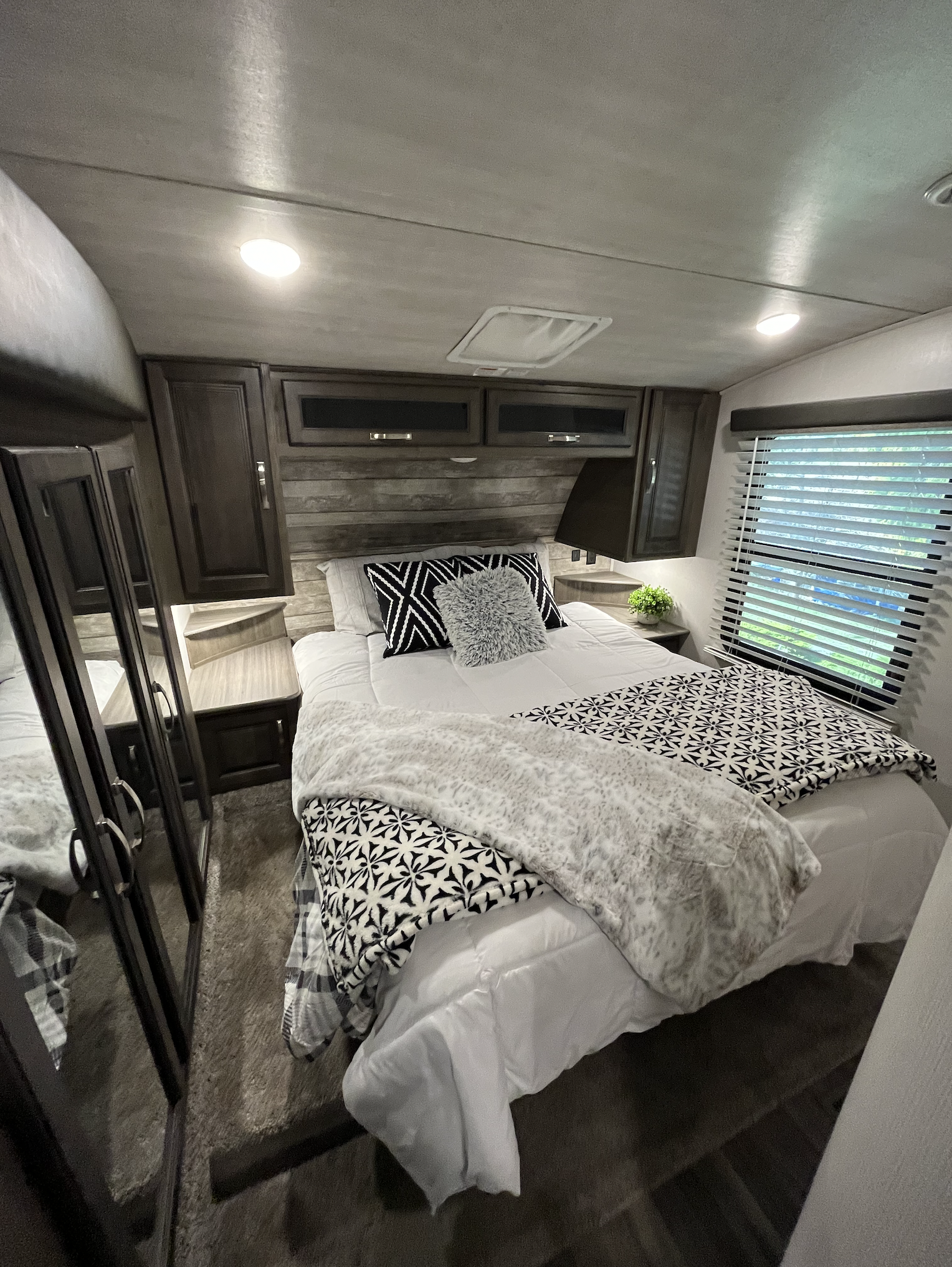 Step into comfort! This modern RV rental bedroom offers a cozy escape with ample storage and natural light.. Keystone RV Cougar 2021