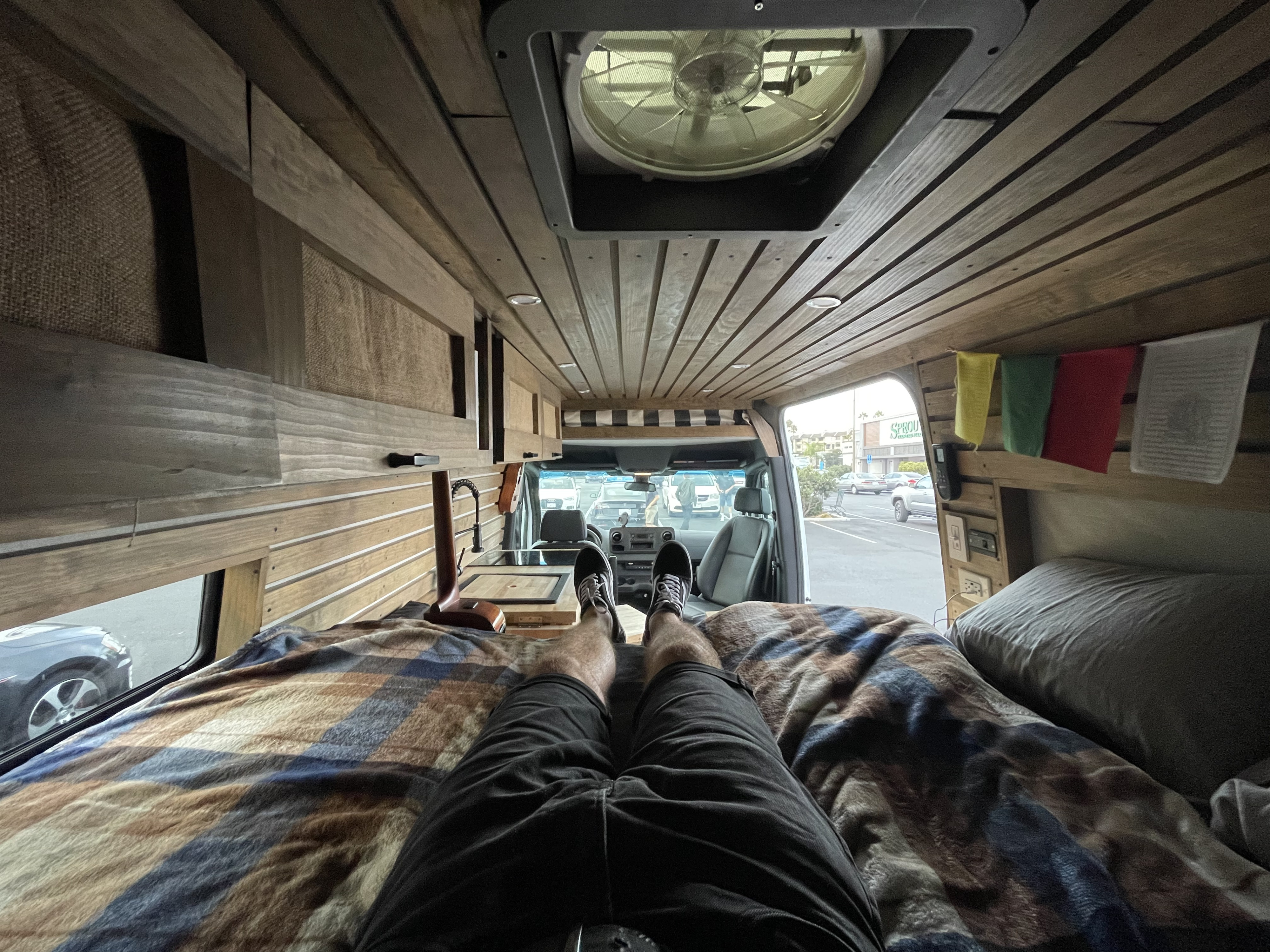 Kick back in a comfy RV rental! Enjoy this customized van's wood paneling, kitchenette, and outside view.. Mercedes-Benz Sprinter 2020