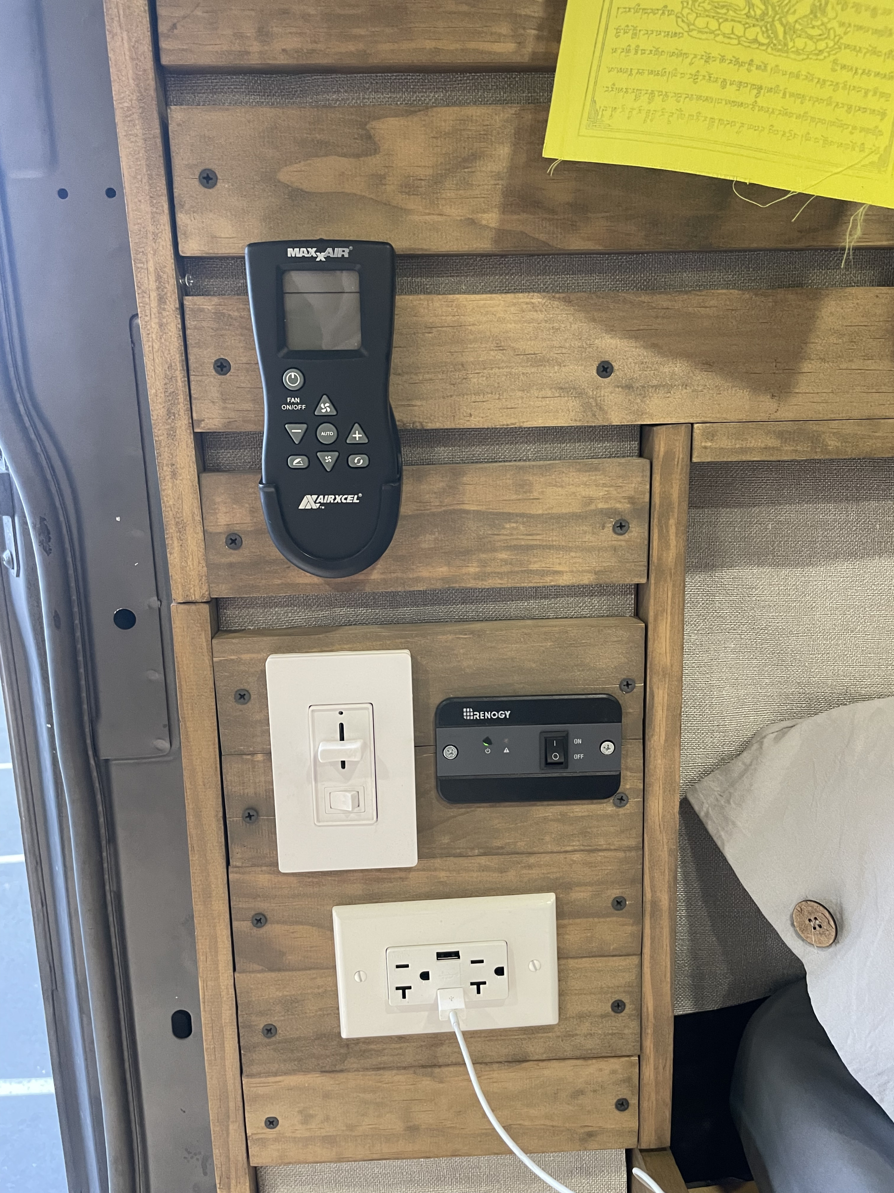 RV rental van's interior wall with MaxxAir fan remote, light dimmer, Renogy power switch, and USB outlet.. Mercedes-Benz Sprinter 2020