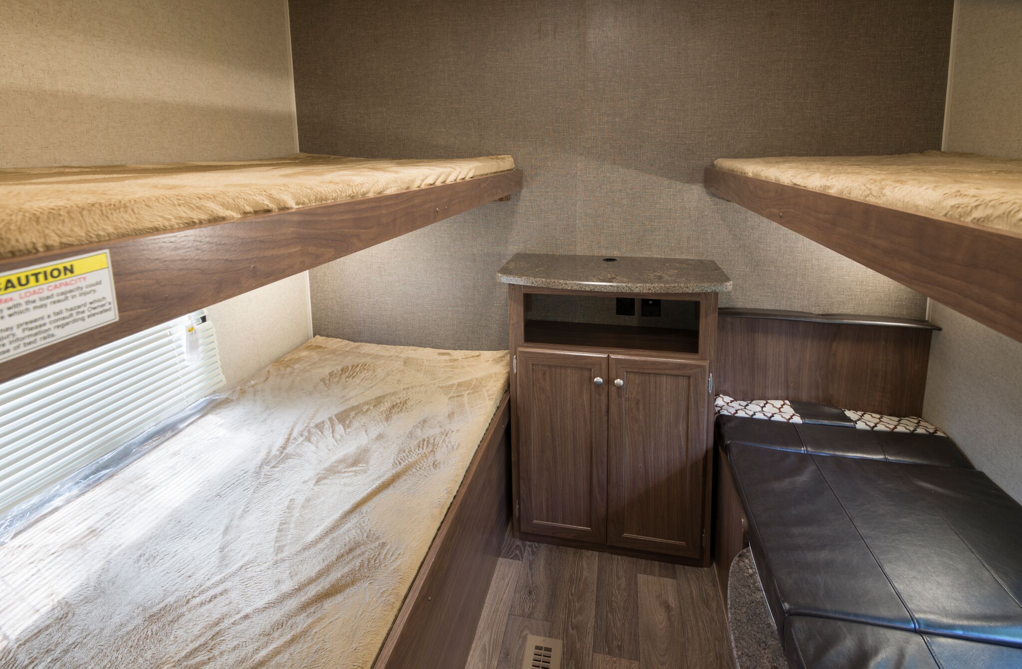 RV rental's compact bunk bed area features four sleeping berths and a central storage cabinet.. Heartland RVs Prowler Lynx 2018