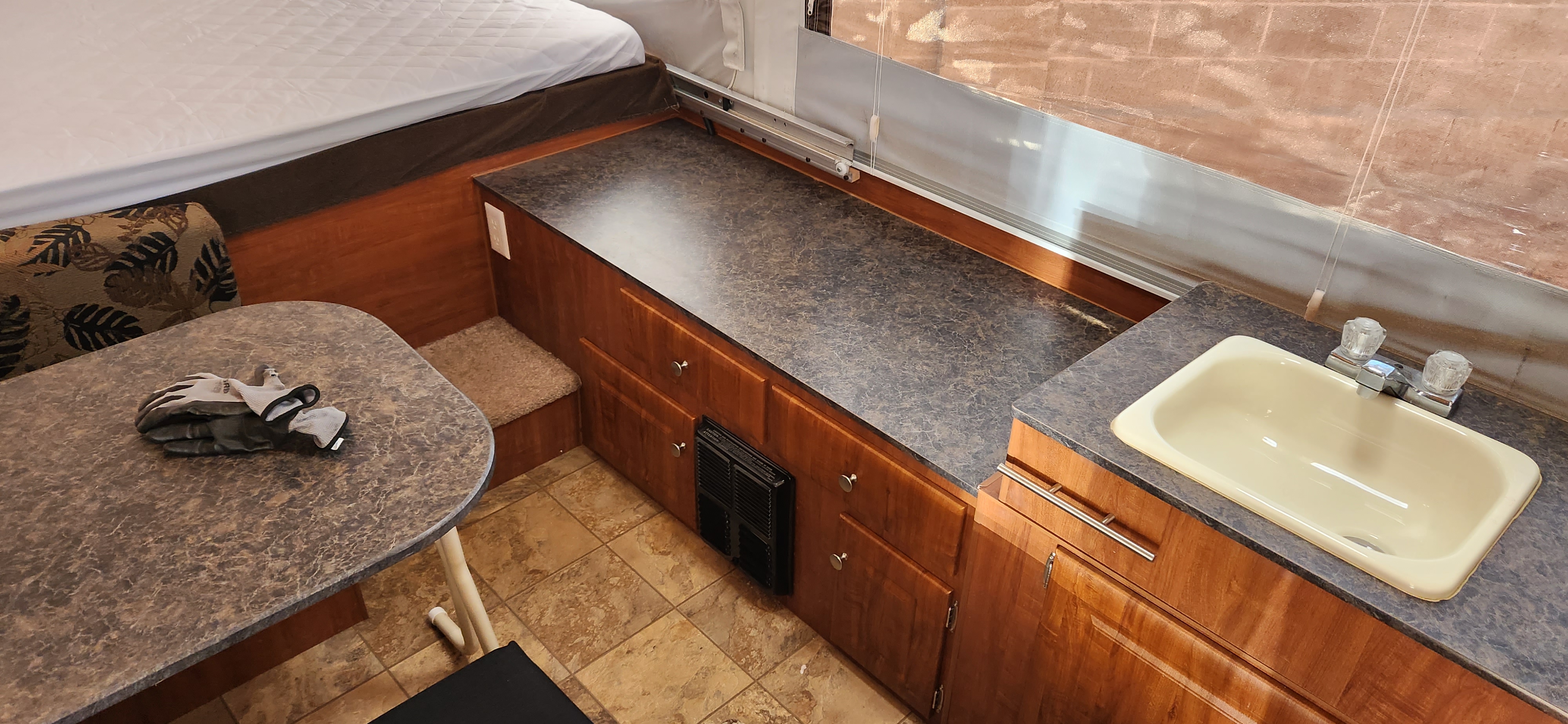 RV rental interior: bed, dining area with gloves, and kitchenette with sink & counter.. Jayco Jay 2012