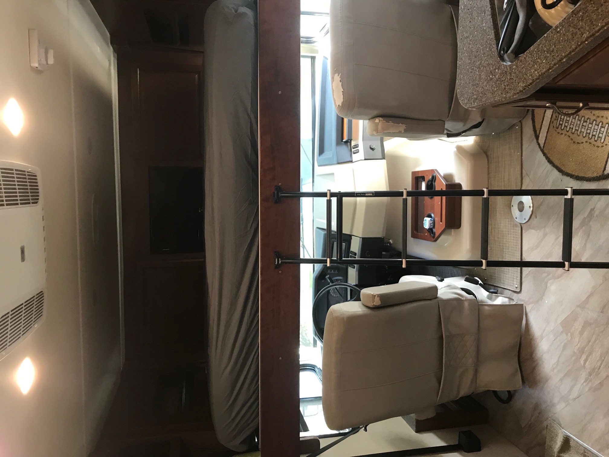 This RV rental interior features an overhead bunk, driver's and passenger seats, and a kitchen counter for your travels.. Fleetwood Bounder 2016