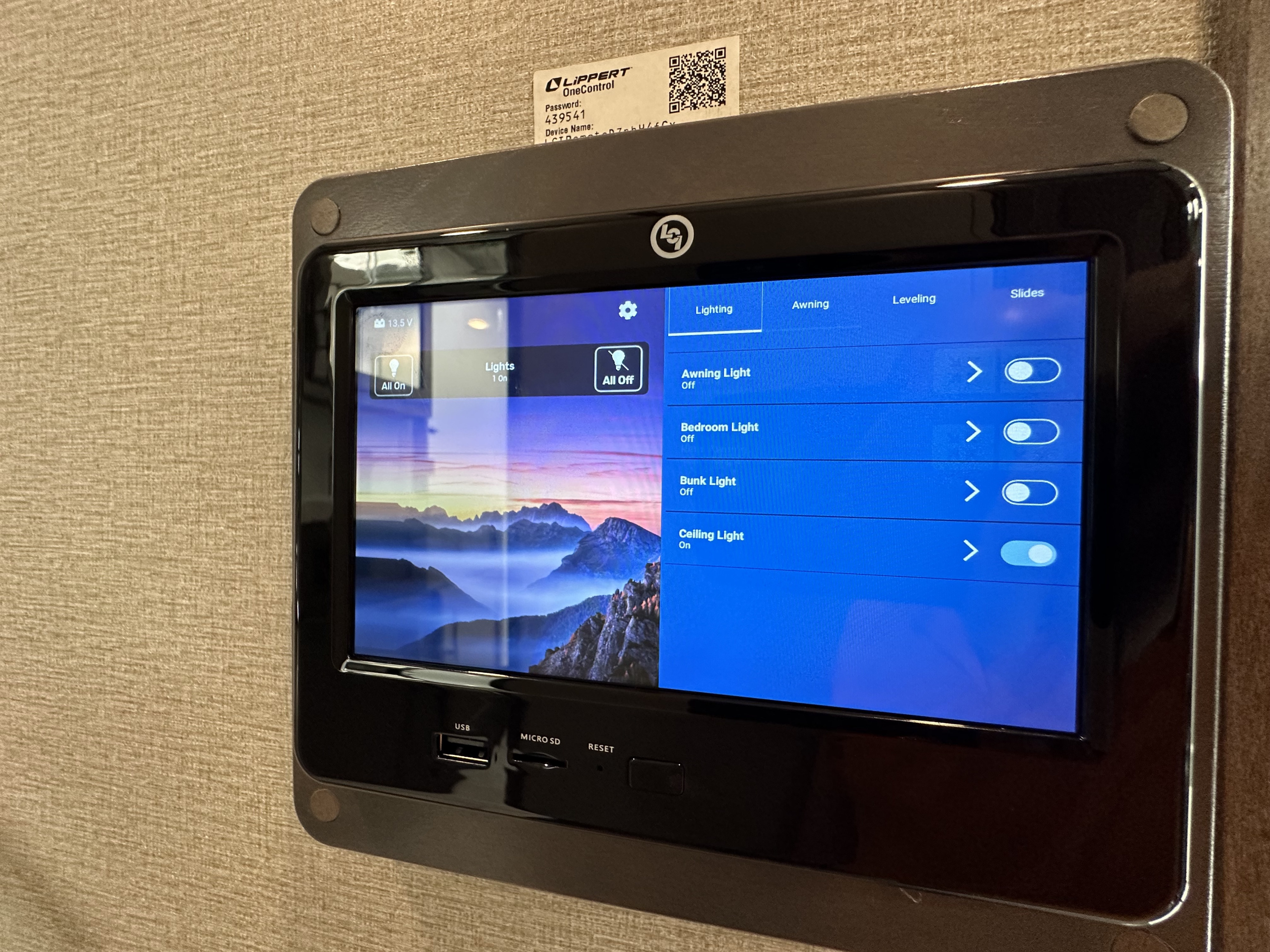 An RV rental features a Lippert OneControl smart panel displaying lighting, awning, leveling, and slide functions with digital toggles.. Grand Design Solitude S-Class 2023