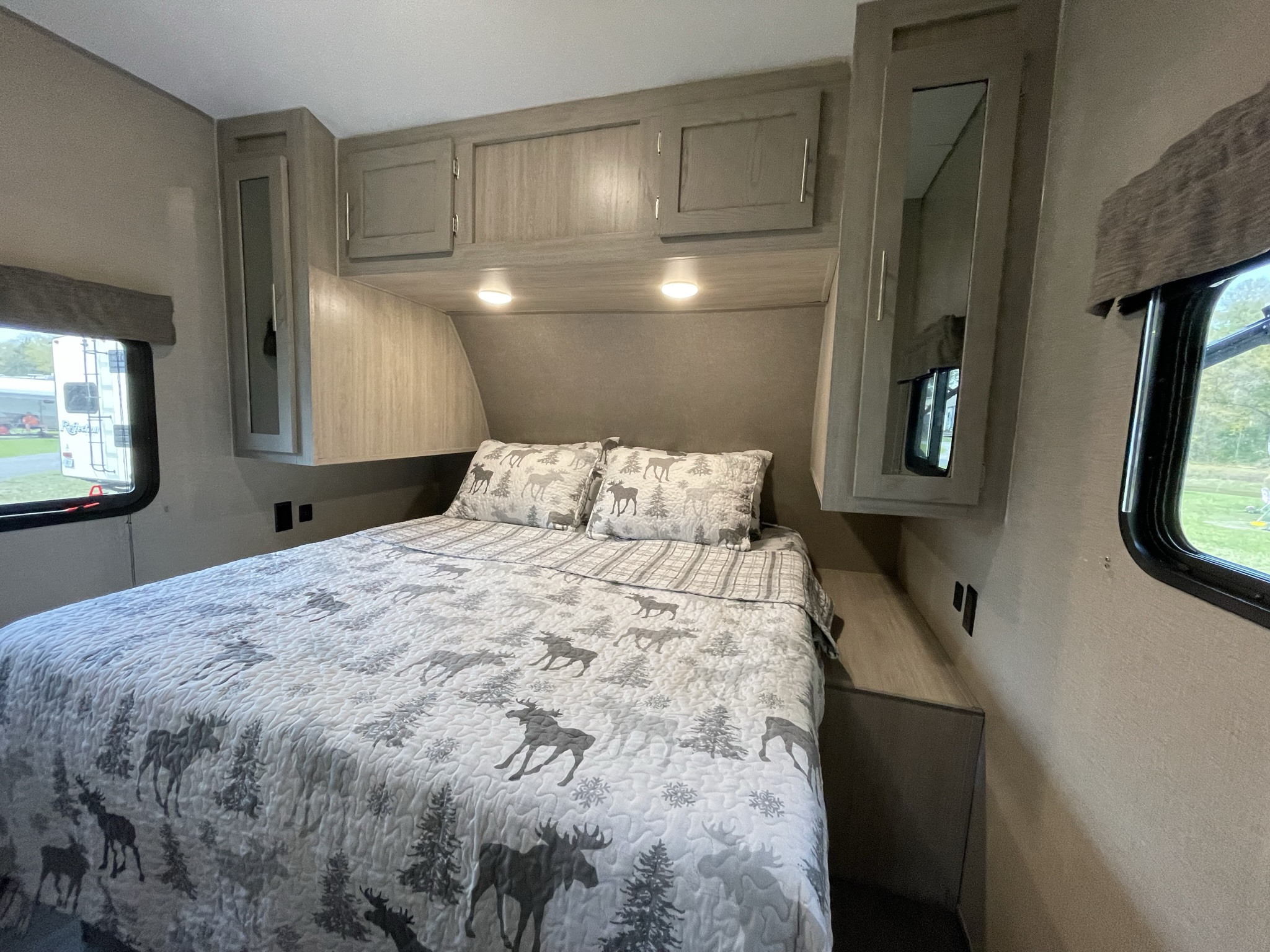 Primary Bedroom - Queen Bed with linens and additional storage underneath. Forest River Coachmen Aurora 2022