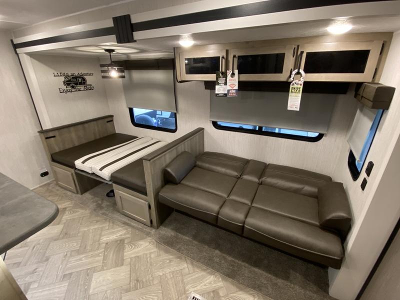 Comfortable RV rental interior with a convertible dinette and sofa, creating a versatile living space for travel.. Forest River Palomino Puma 2022