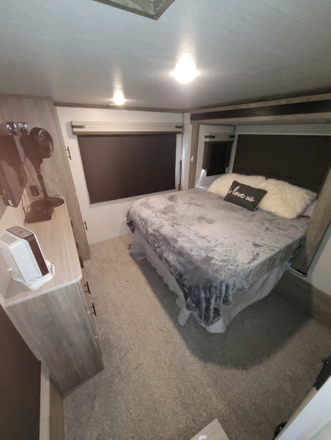 Cozy RV rental bedroom with a comfortable bed, bedside dresser, and window. Ideal for mobile living.. Forest River Salem Hemisphere 2021