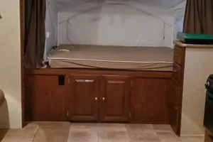 This RV rental features a comfortable pop-out bed with canvas sides, offering ample sleeping space. Perfect for your camper adventure!. Forest River Rockwood Roo 2011