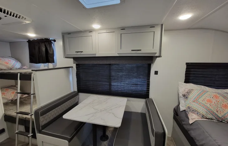 Step inside this modern RV rental: featuring bunk beds, a cozy dinette, and a comfy main bed for your next adventure.. Forest River Salem FSX 2021