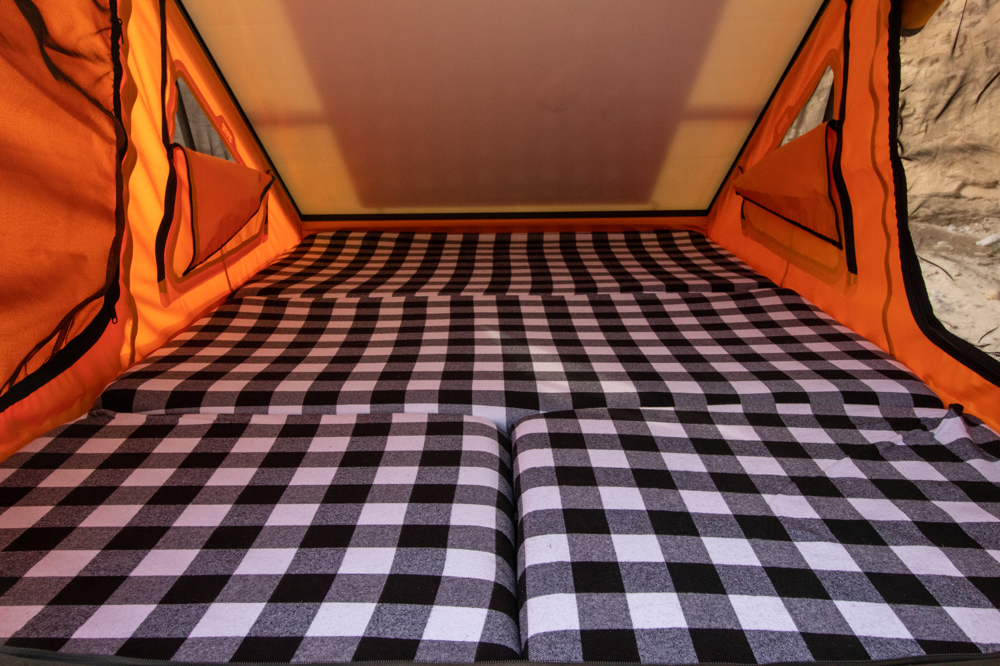 RV rental tent interior: cozy black and white checkered mattress for comfortable camping adventures.. Ram Power Wagon 2022