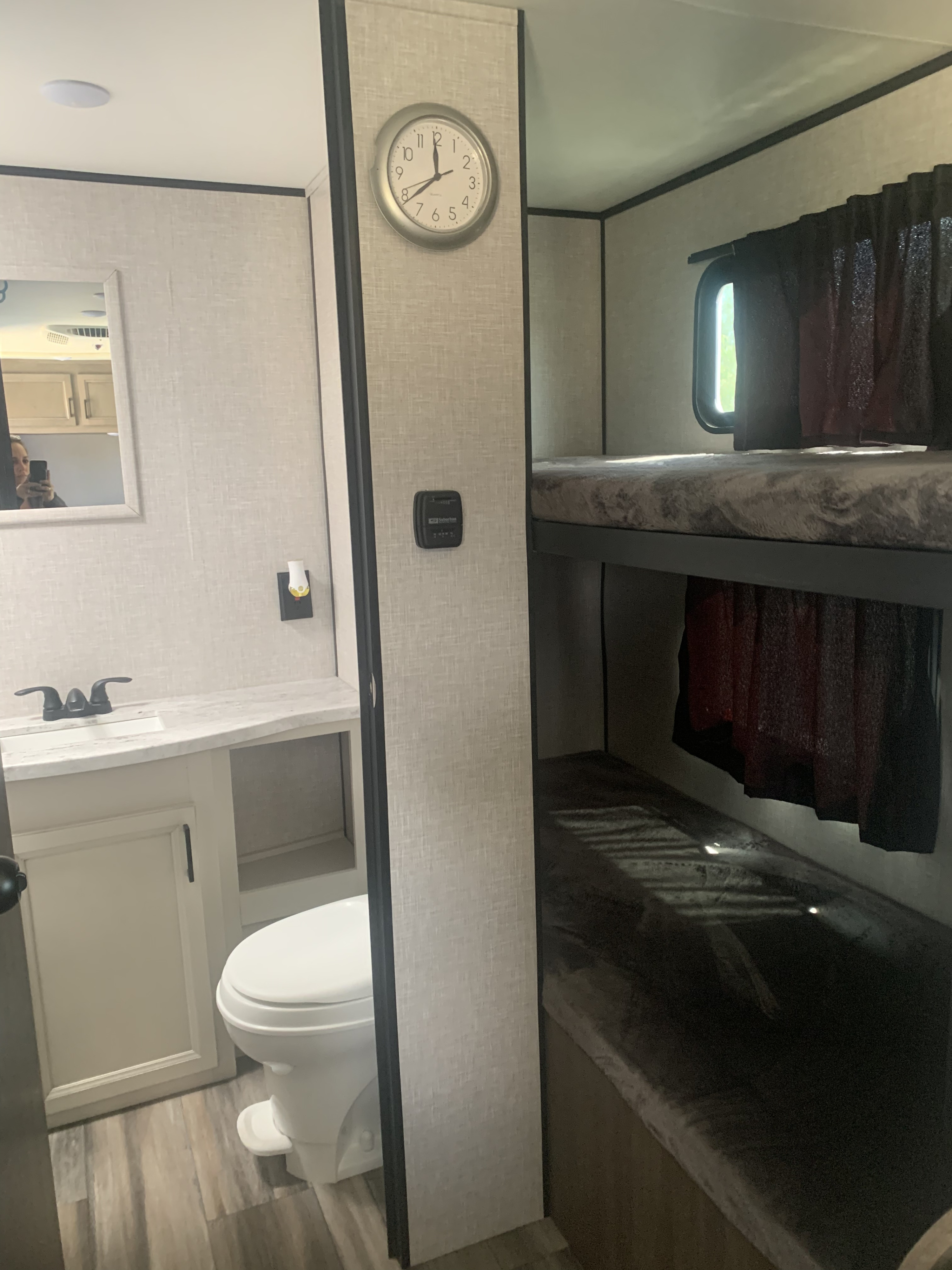 RV rental: Inside, a bathroom with sink and toilet next to bunk beds.. Highland Ridge Open Range 2023
