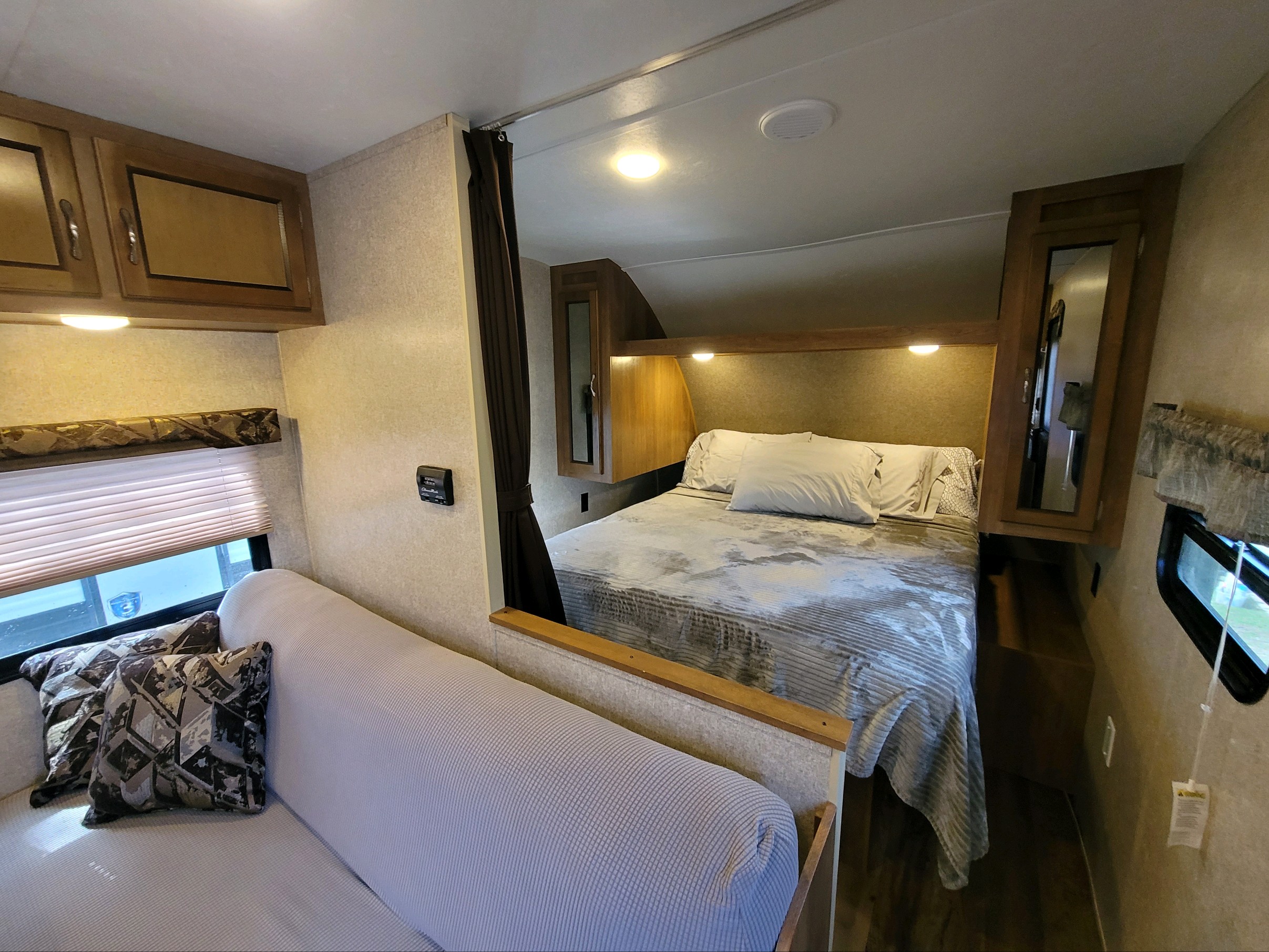 RV rental: See the cozy interior featuring a bedroom with a comfy bed, and a living area with a sofa. Compact and functional.. Forest River Catalina 2017