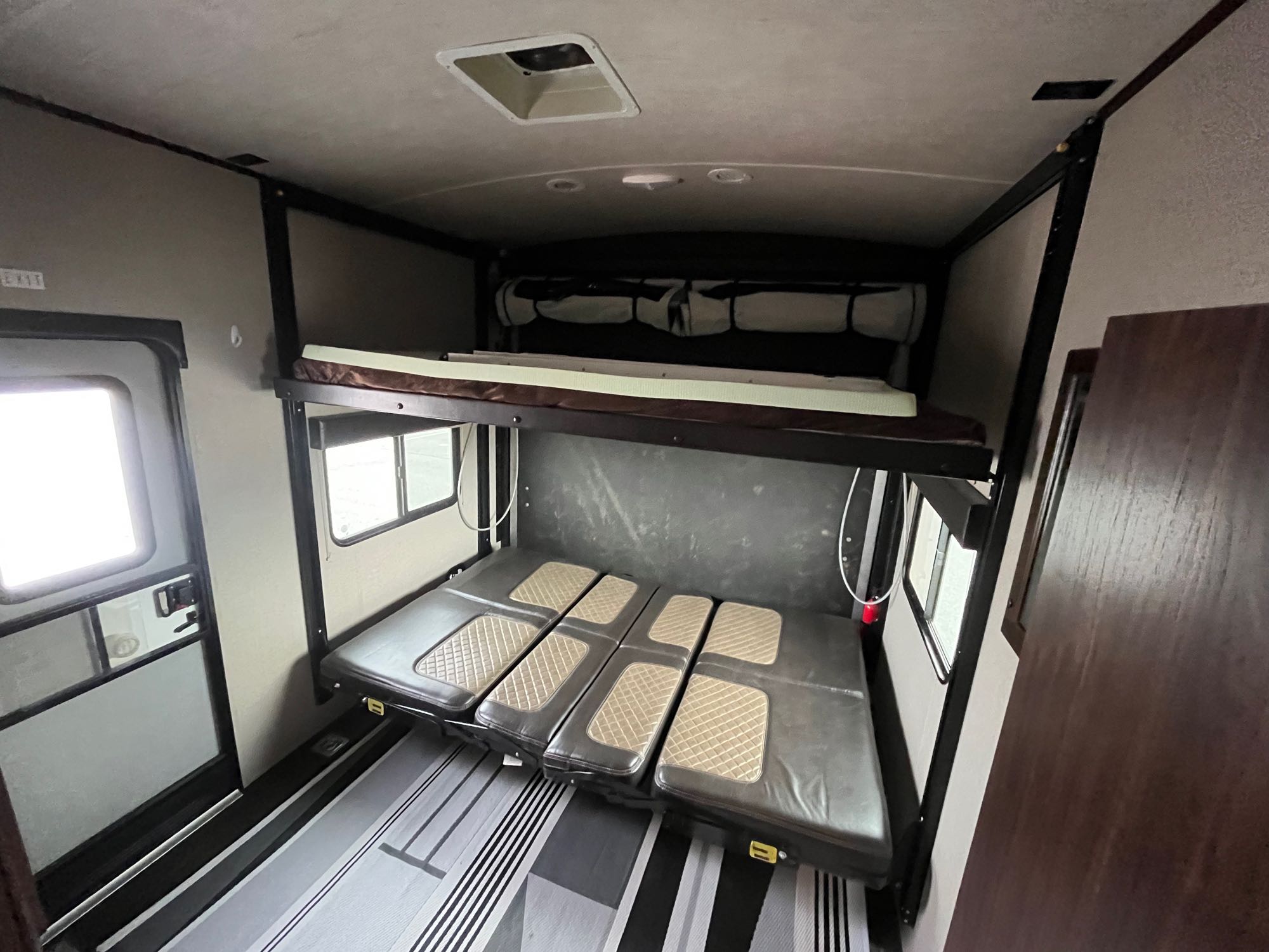 RV rental interior features bunk beds: a raised upper bed and a lowered multi-cushion bed/dinette.. Other Other 2017