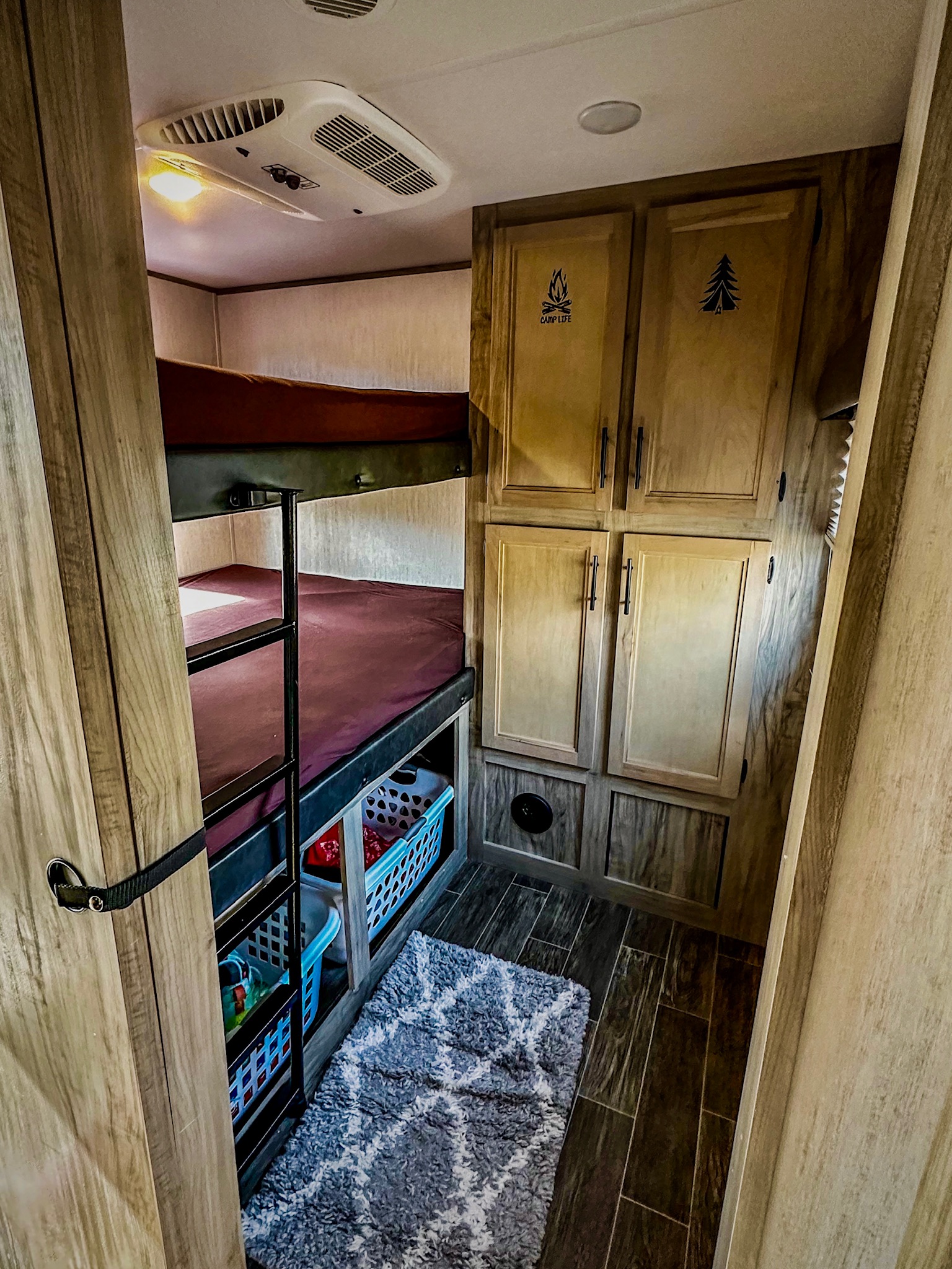 RV rental bunkhouse featuring comfortable bunk beds, ample storage, and ceiling AC. A cozy space for family adventures.. Forest River Cherokee Alpha Wolf 2021