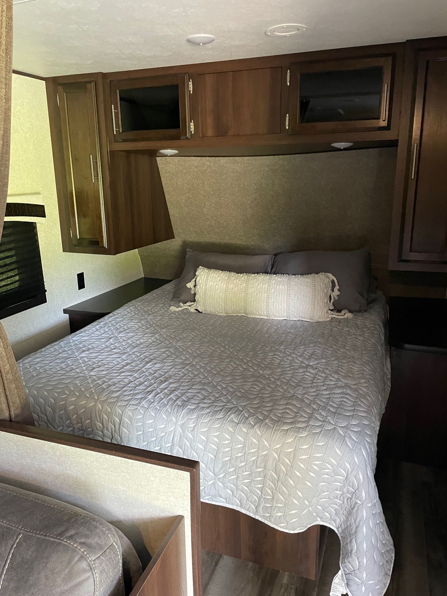 Cozy RV rental bedroom with a comfy bed, overhead storage, and window. Perfect for your next adventure!. Jayco Jay Flight 2020