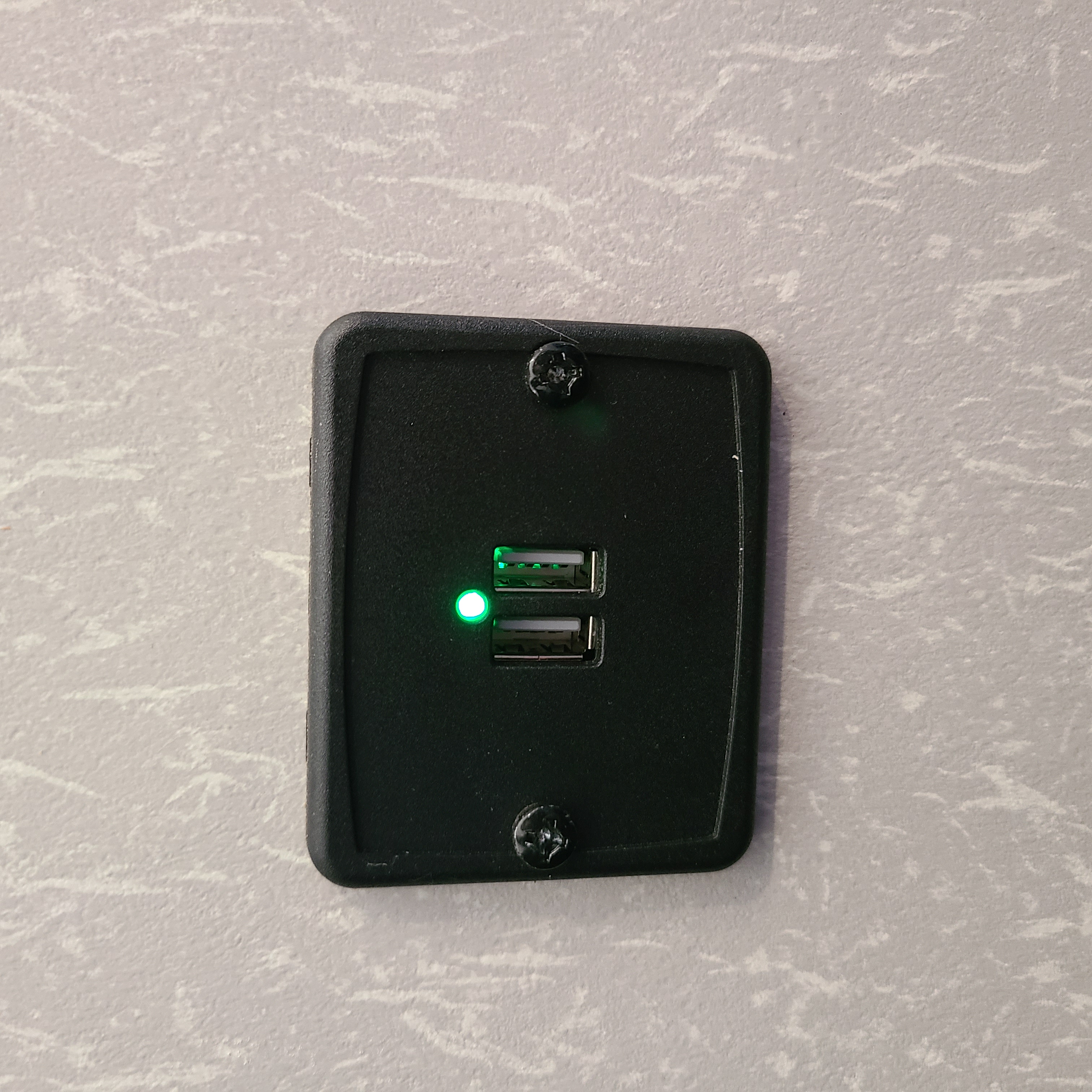 Green light on dual USB charging ports in an RV rental, essential for keeping devices charged on the go.. Forest River Cherokee Grey Wolf Special Edition 2022